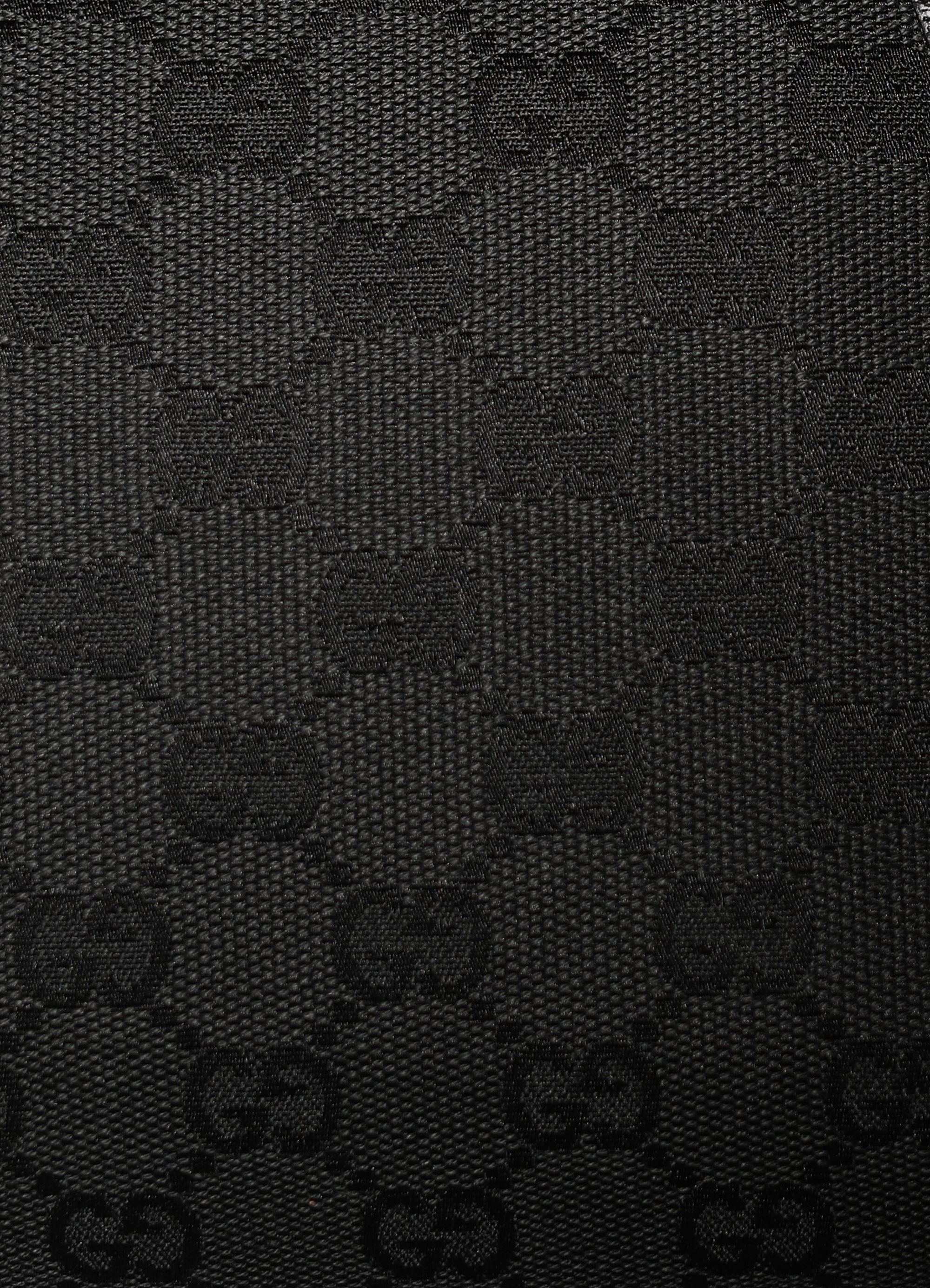 Gucci GG Canvas Tote Bag in black canvas with leather trim showing close up of print