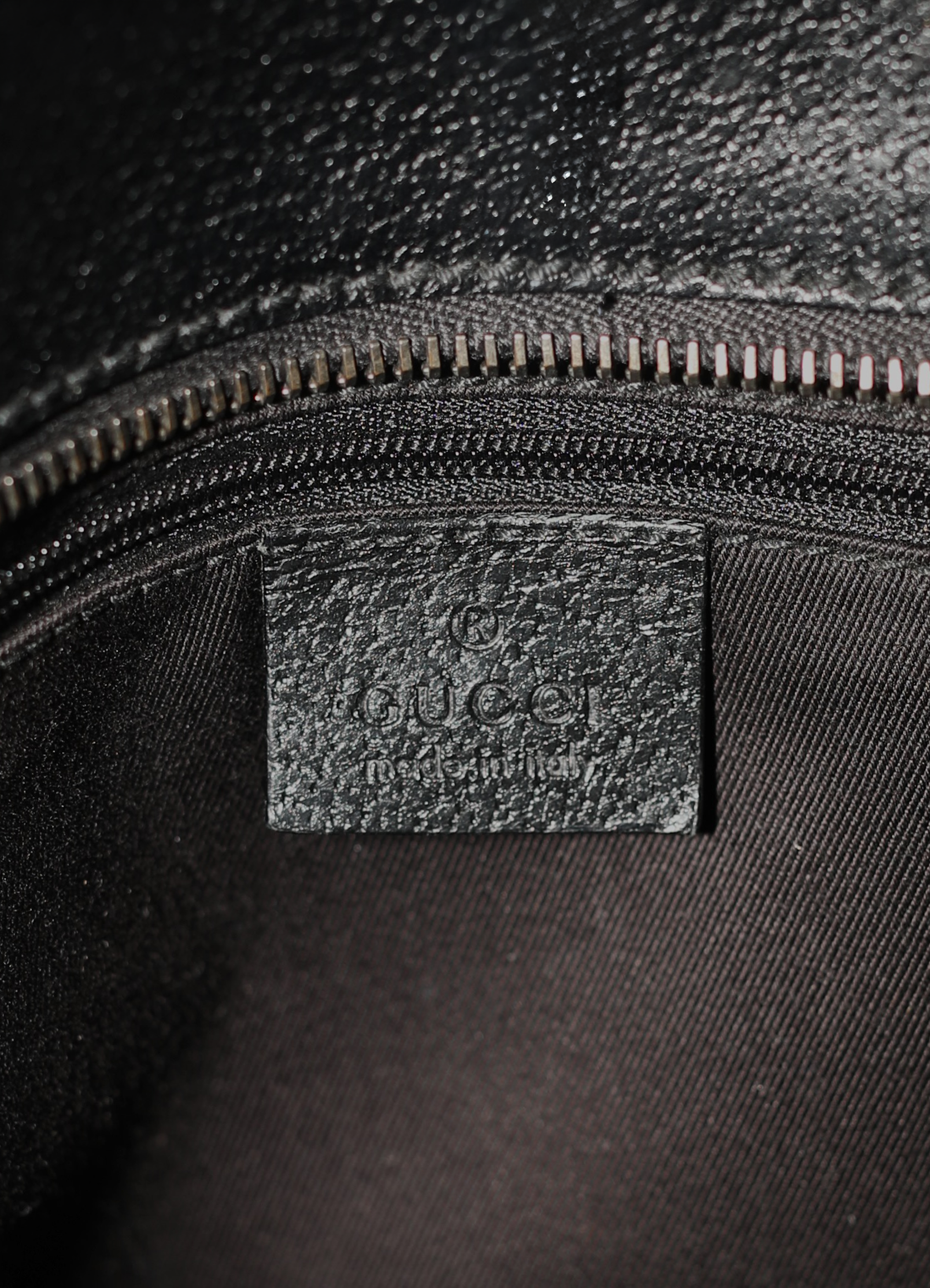 Gucci GG Canvas Tote Bag in black canvas with leather trim showing label tag