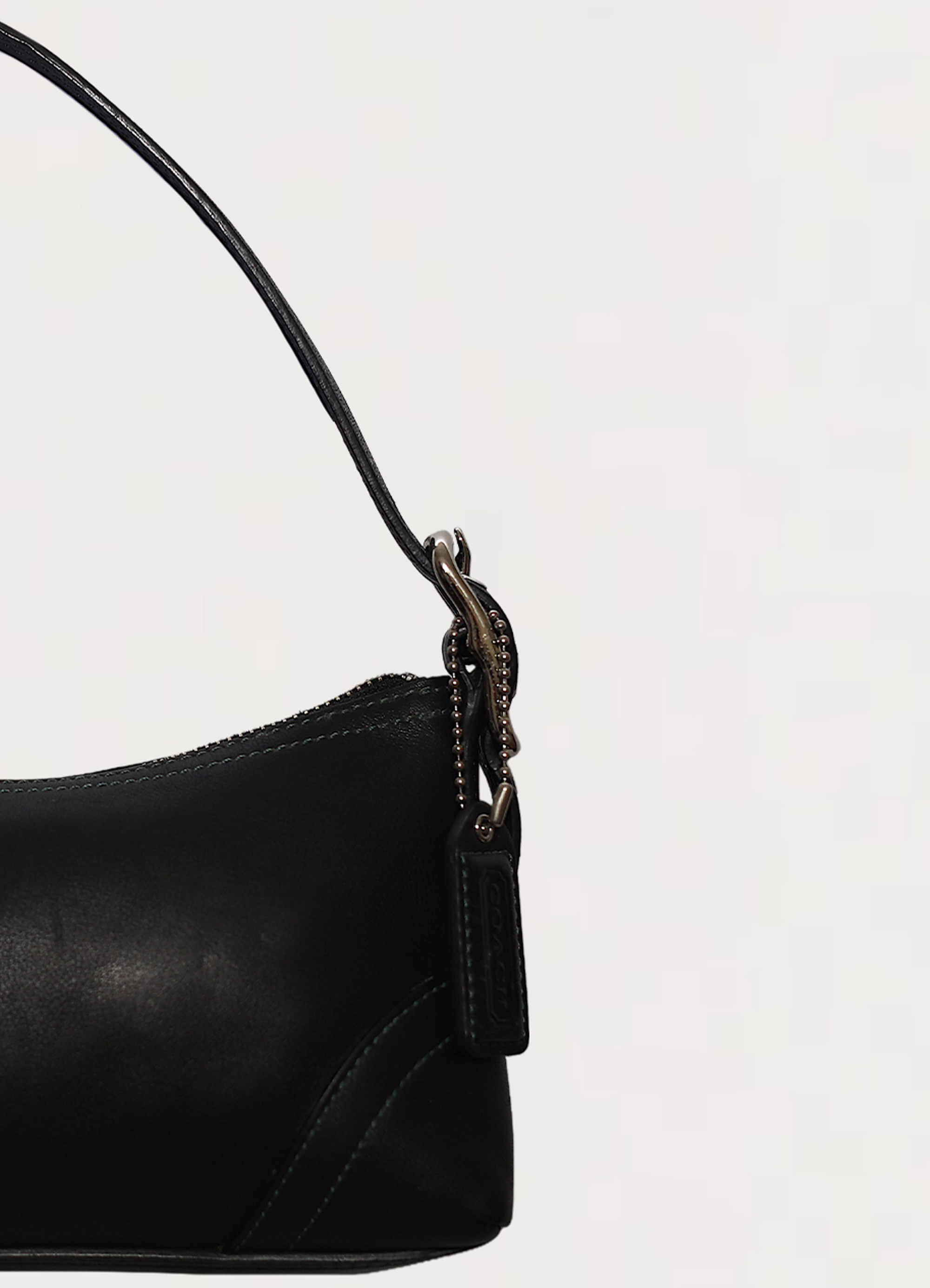 Vintage coach black east west demi leather baguette bag showing close up of hang tag