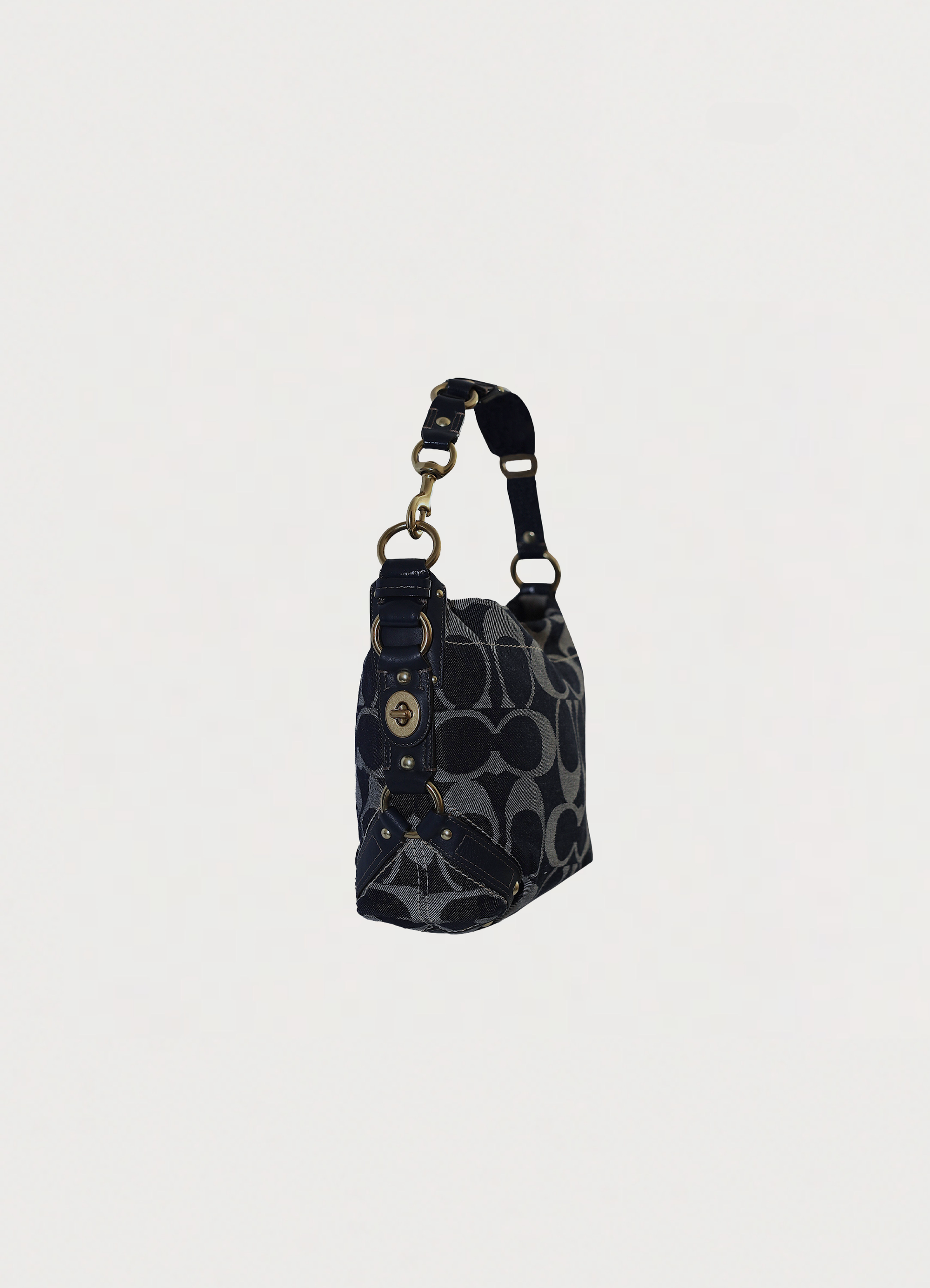 Vintage coach blue denim Carly monogram shoulder bag showing angled side

