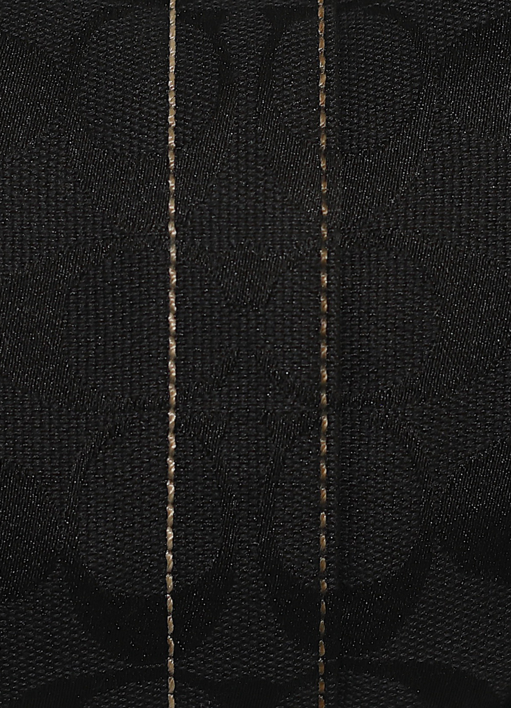 Vintage Coach Soho hobo bag in black signature canvas with leather trim showing close up of print