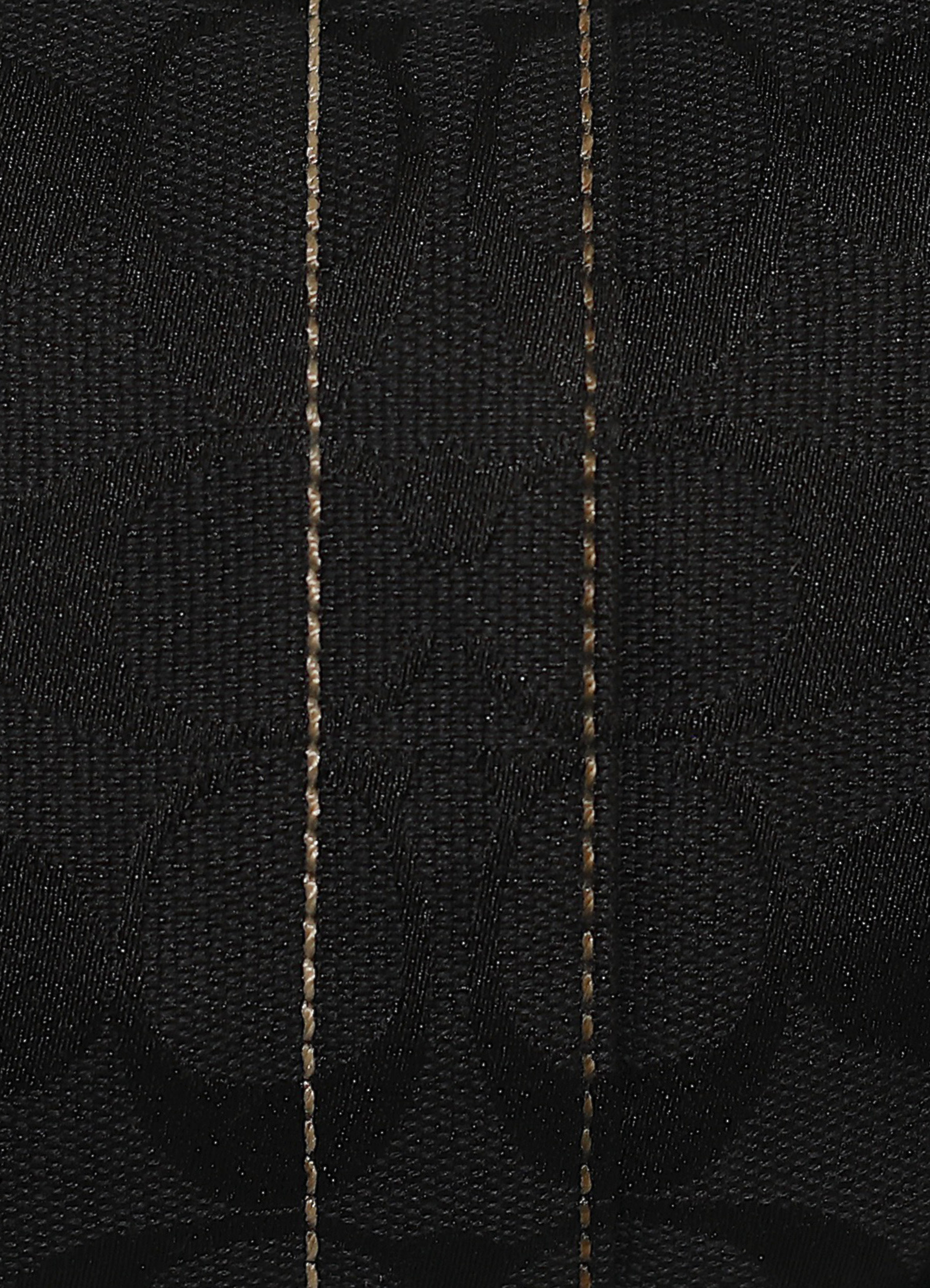 Vintage Coach Soho hobo bag in black signature canvas with leather trim showing close up of print