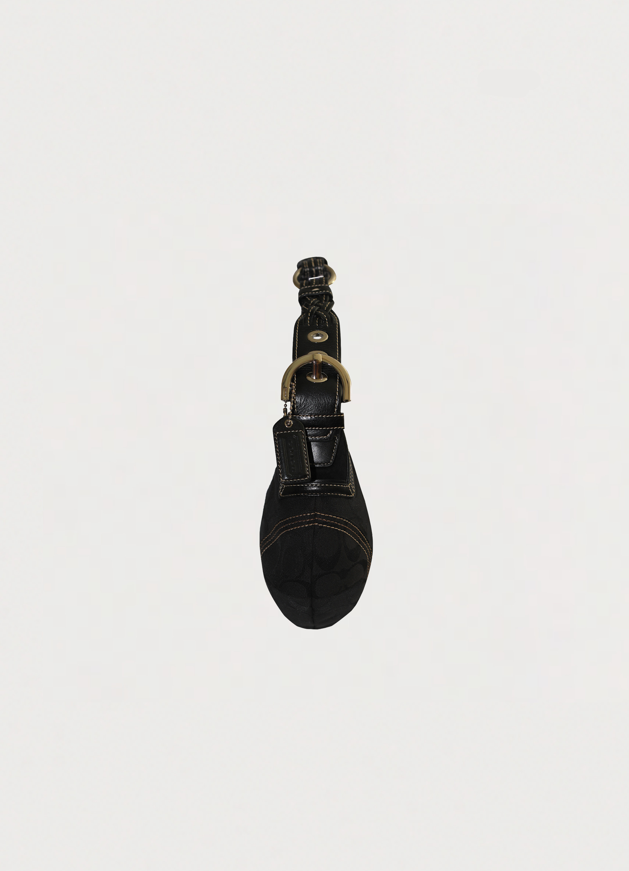 Vintage Coach Soho hobo bag in black signature canvas with leather trim showing left side