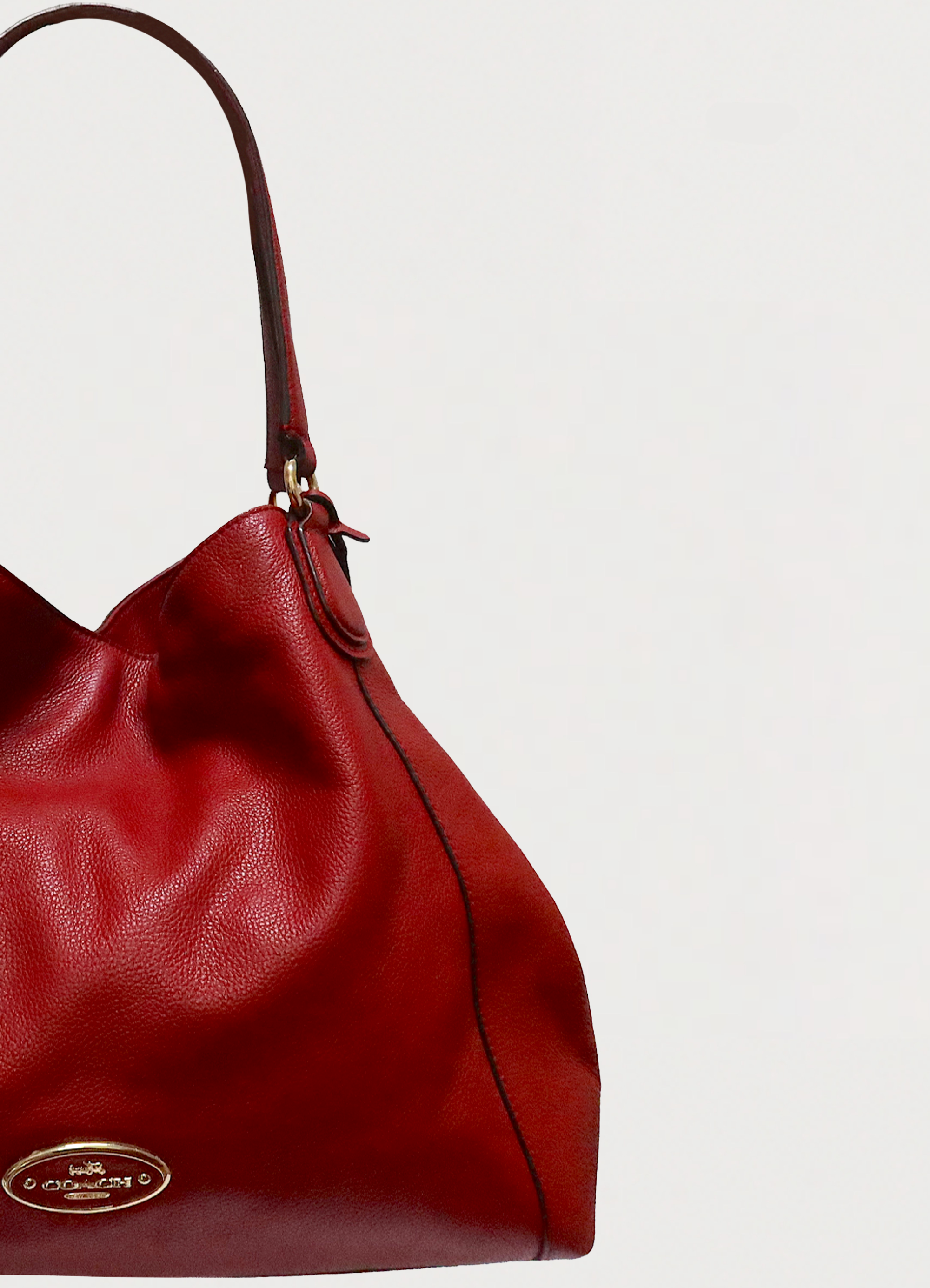 Detail shot of the side gusset and stitching on the red Edie 31 bag