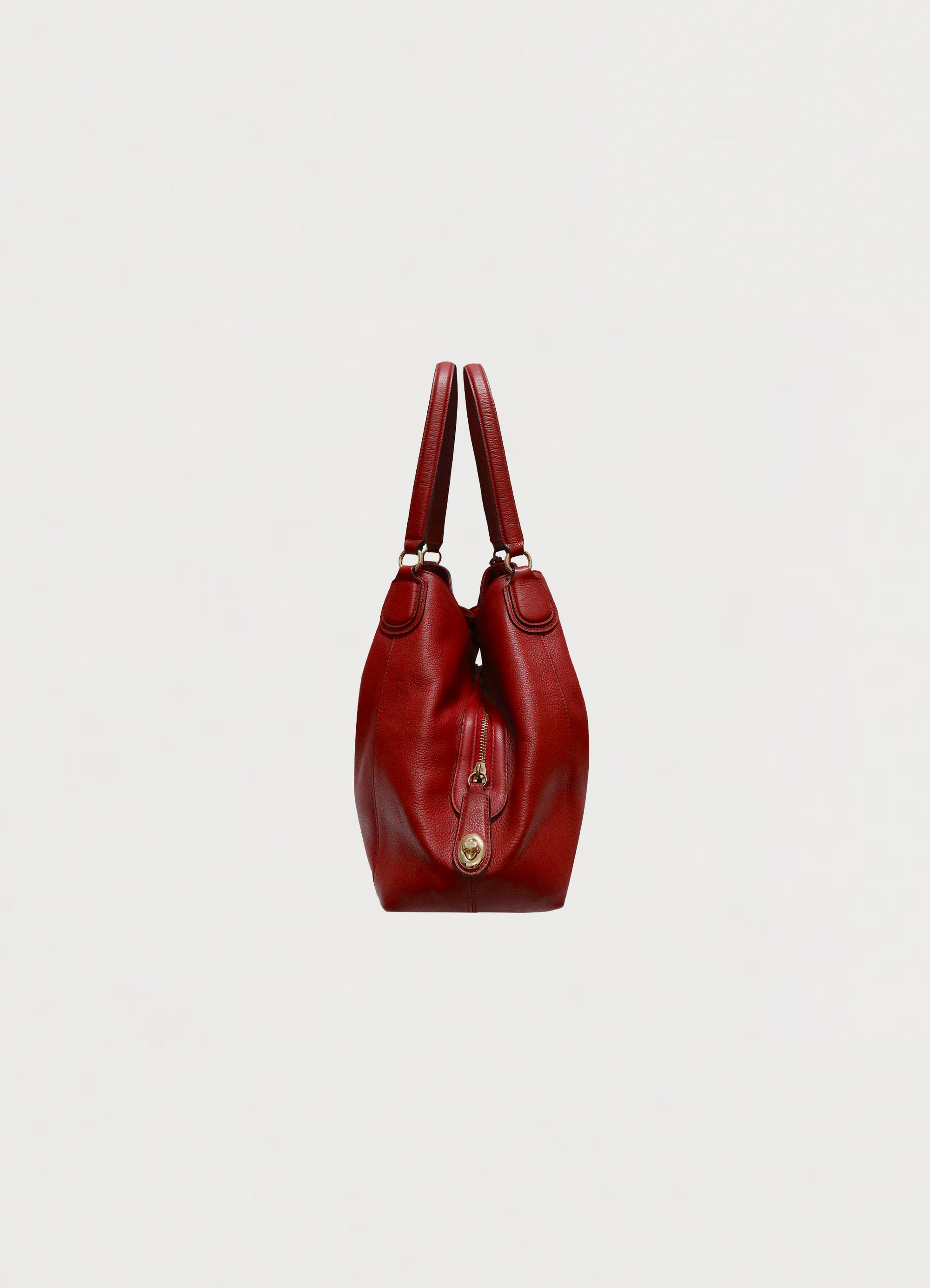 Right side profile of red Coach Edie 31 bag showing silhouette
