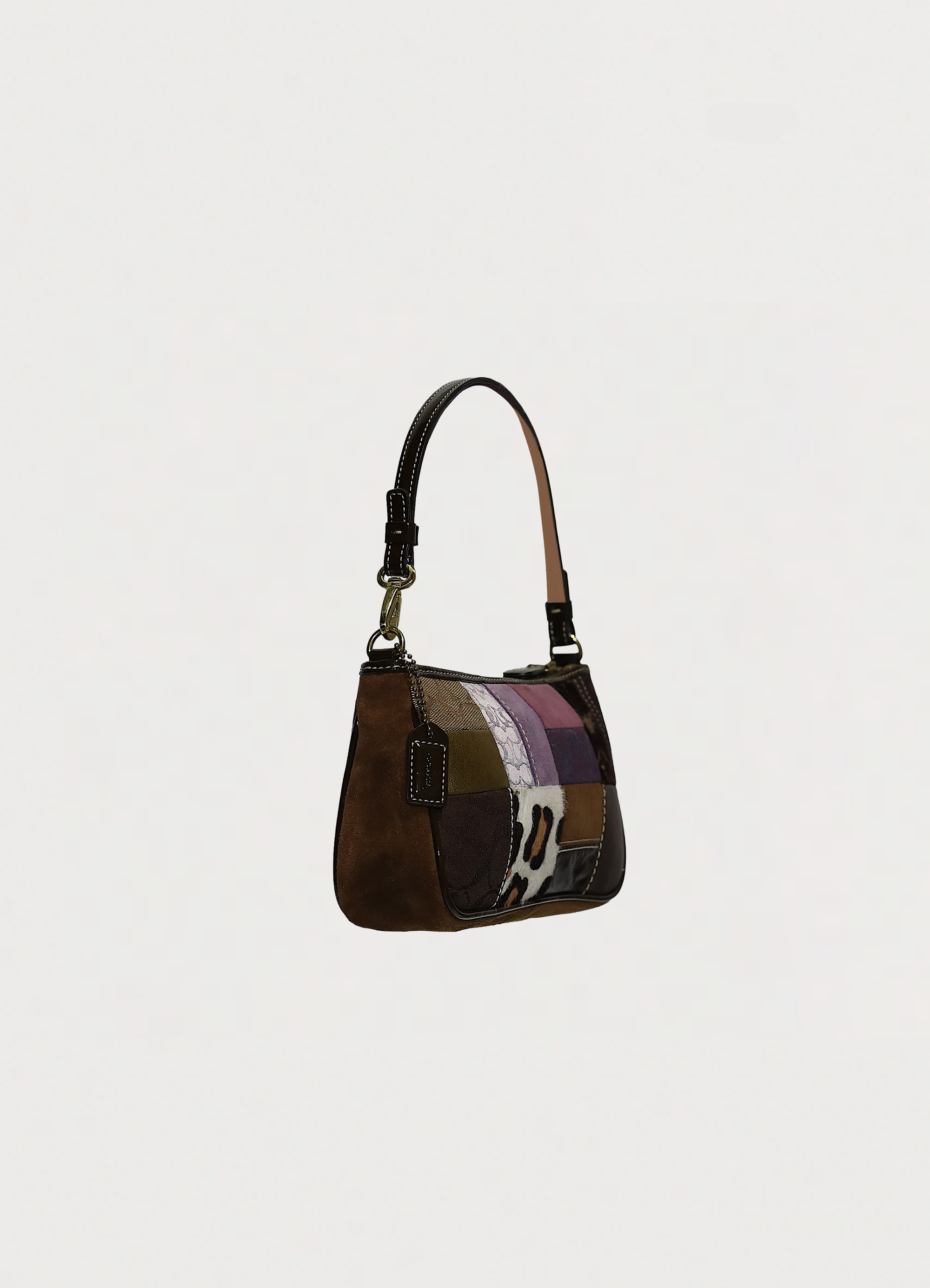 Coach legacy patchwork demi pochette handbag in multi patchwork print showing angled side
