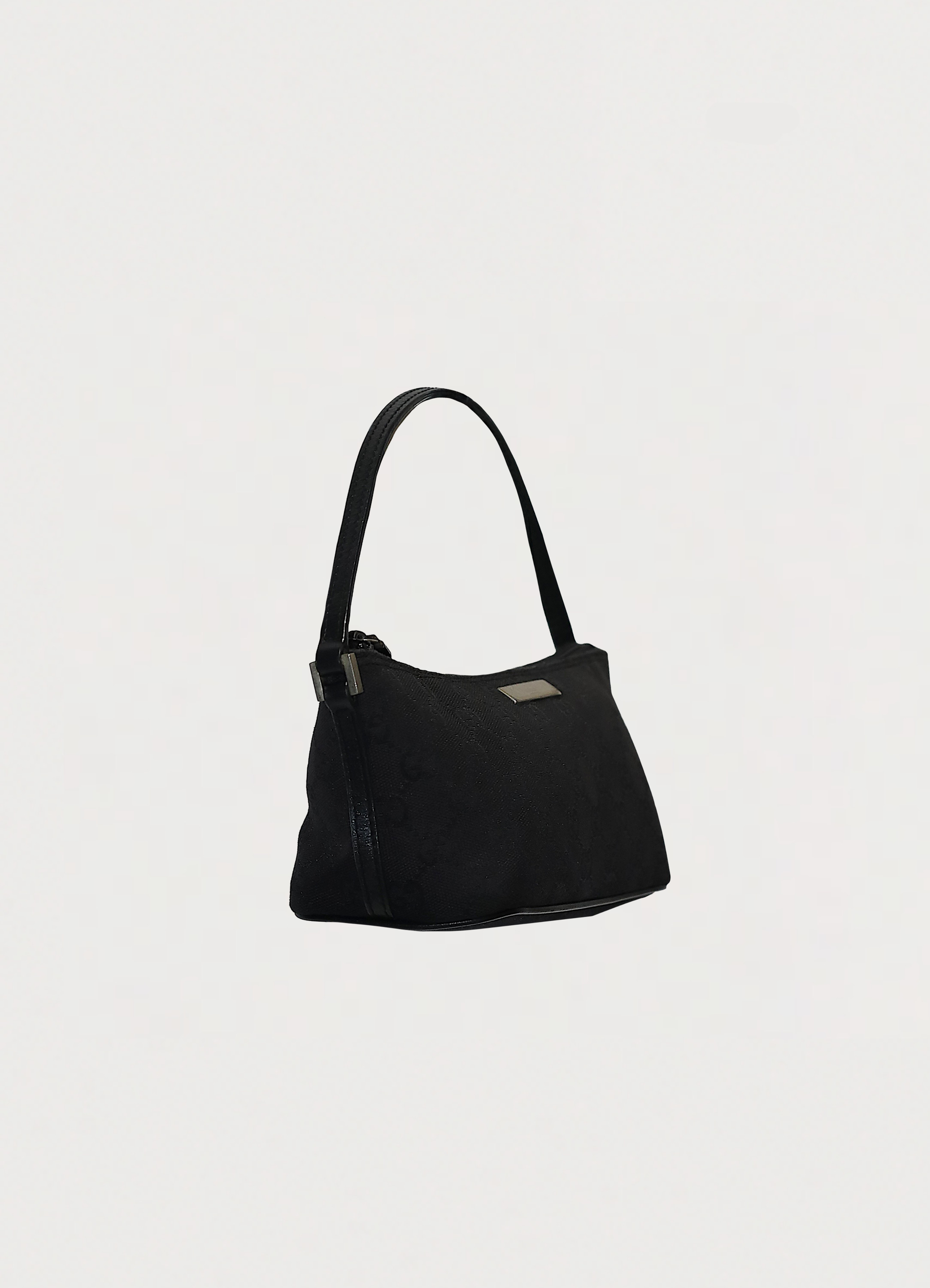 GG monogram boat back in black signature canvas with leather trim showing angled side