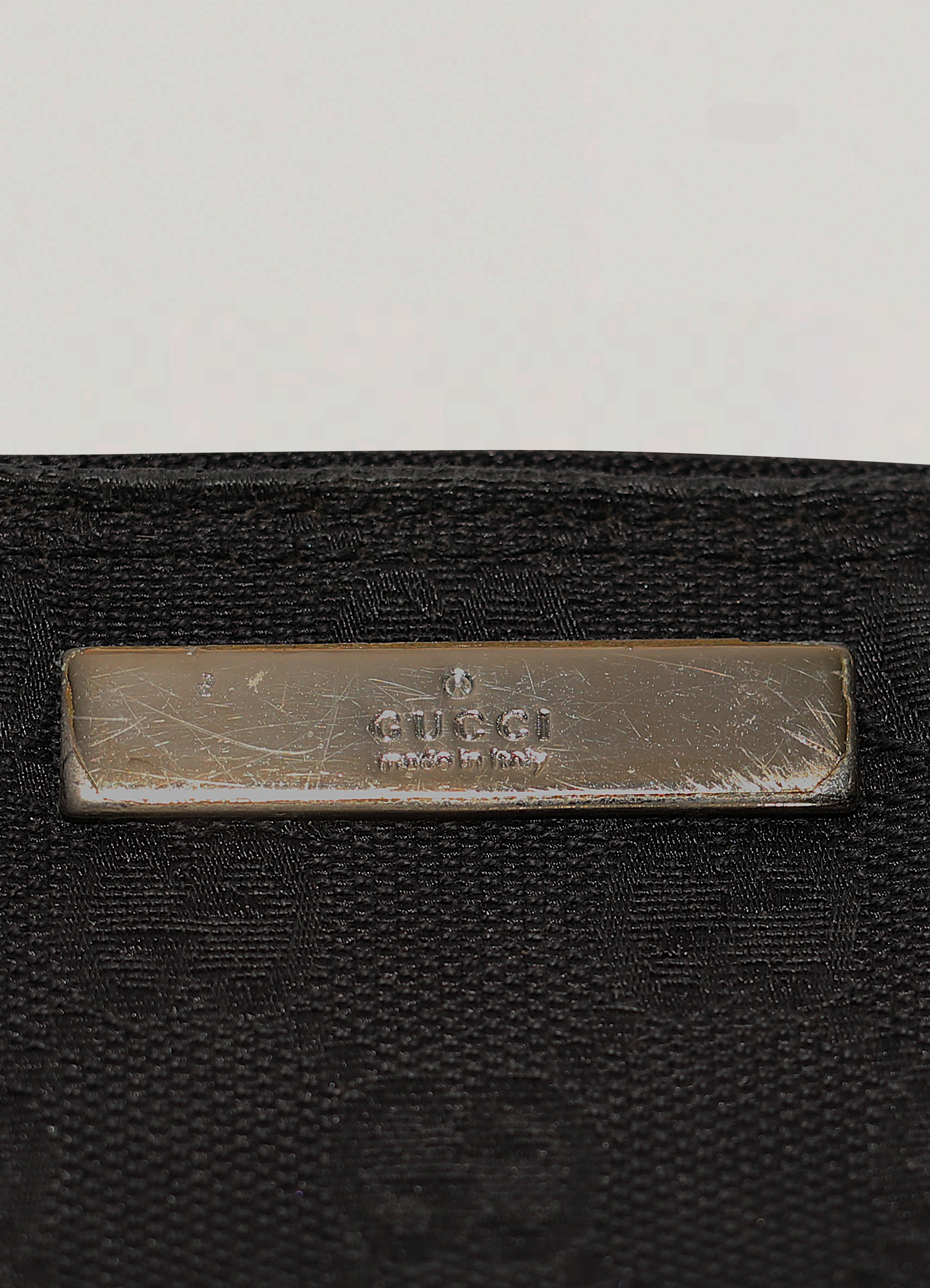 GG monogram boat back in black signature canvas with leather trim showing metal label plate