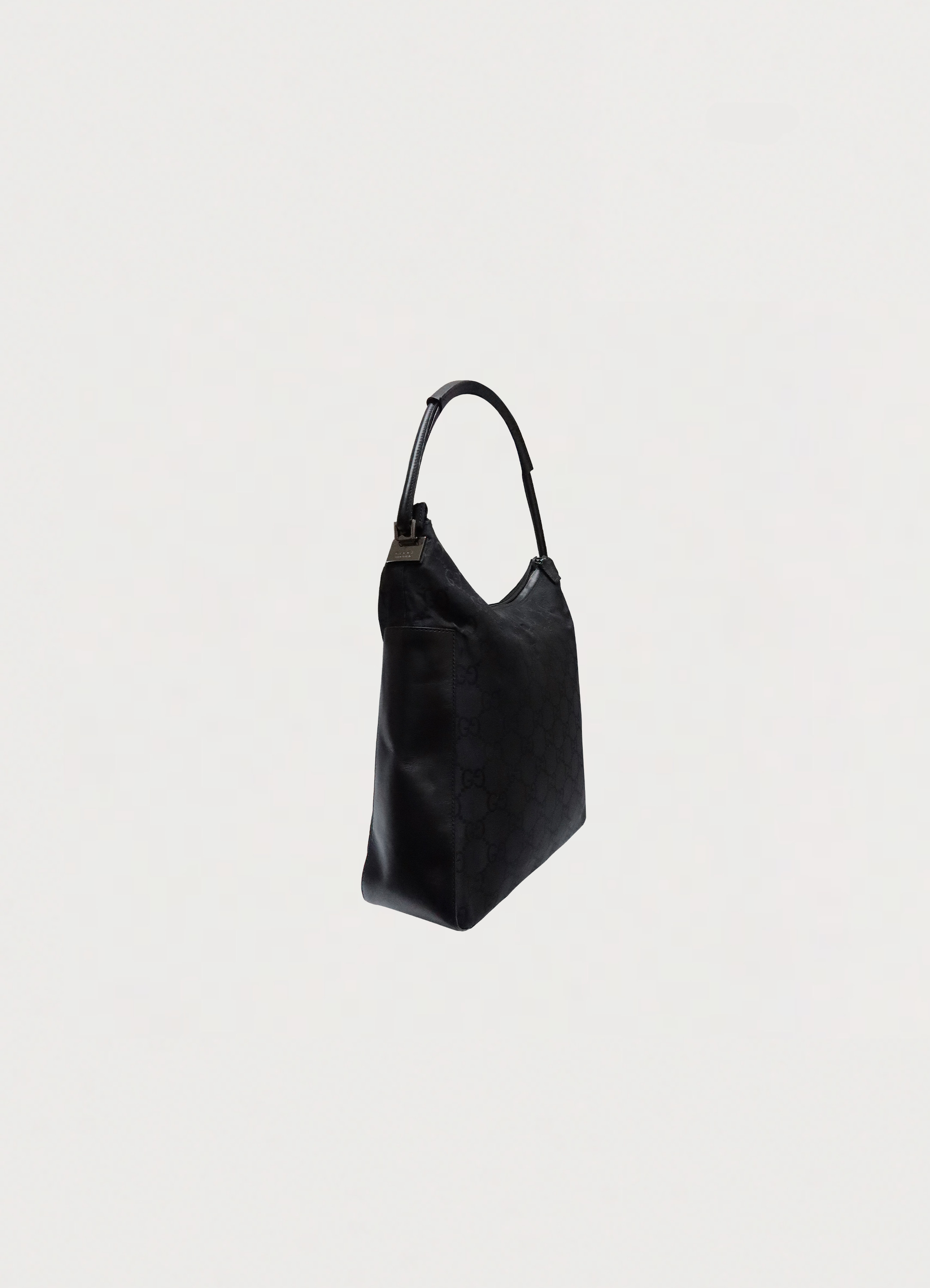 Gucci GG clasp hobo shoulder bag in black monogram canvas angled side view 