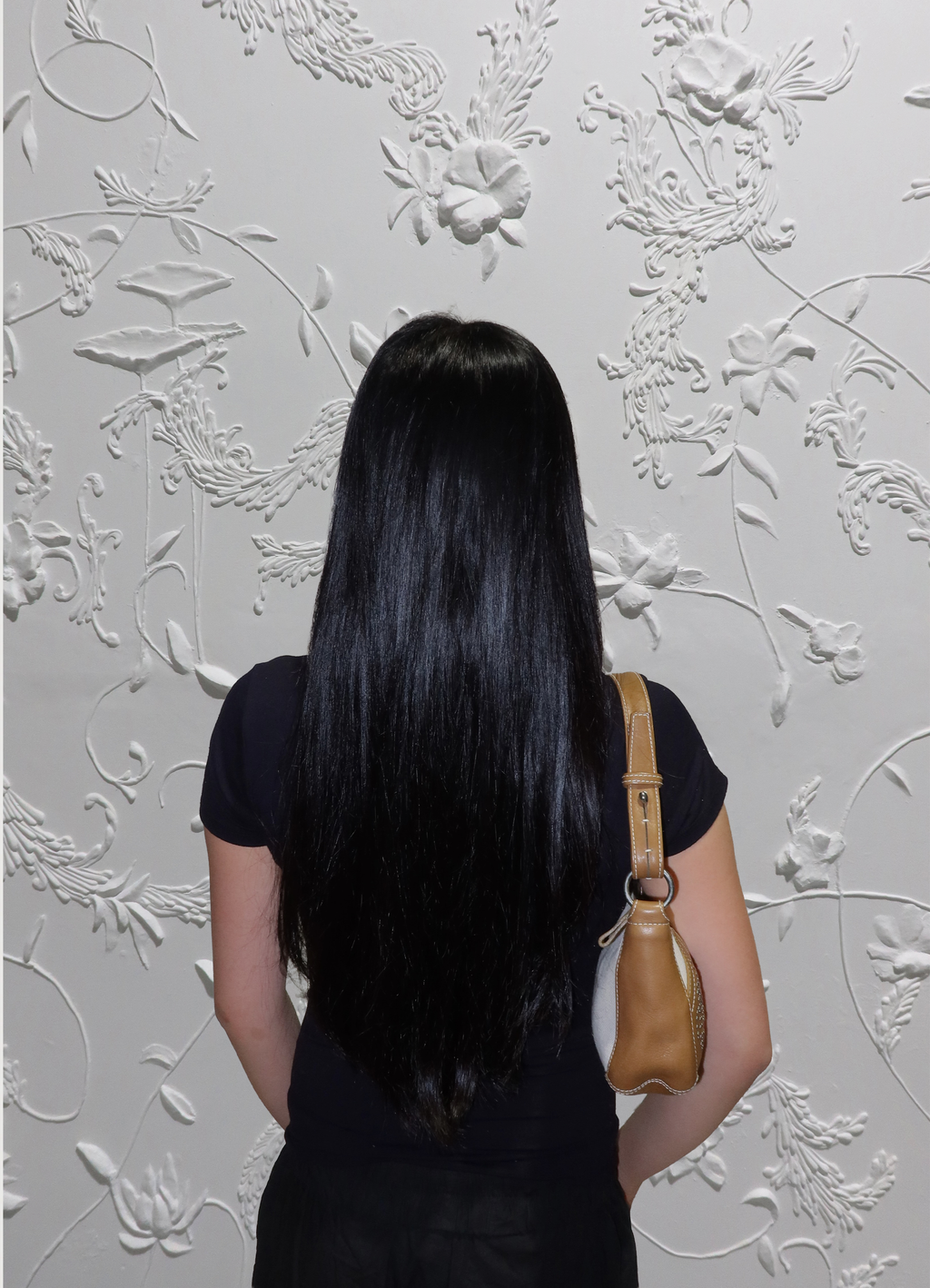 Cream Loewe Anagram pochette bag worn on shoulder by model