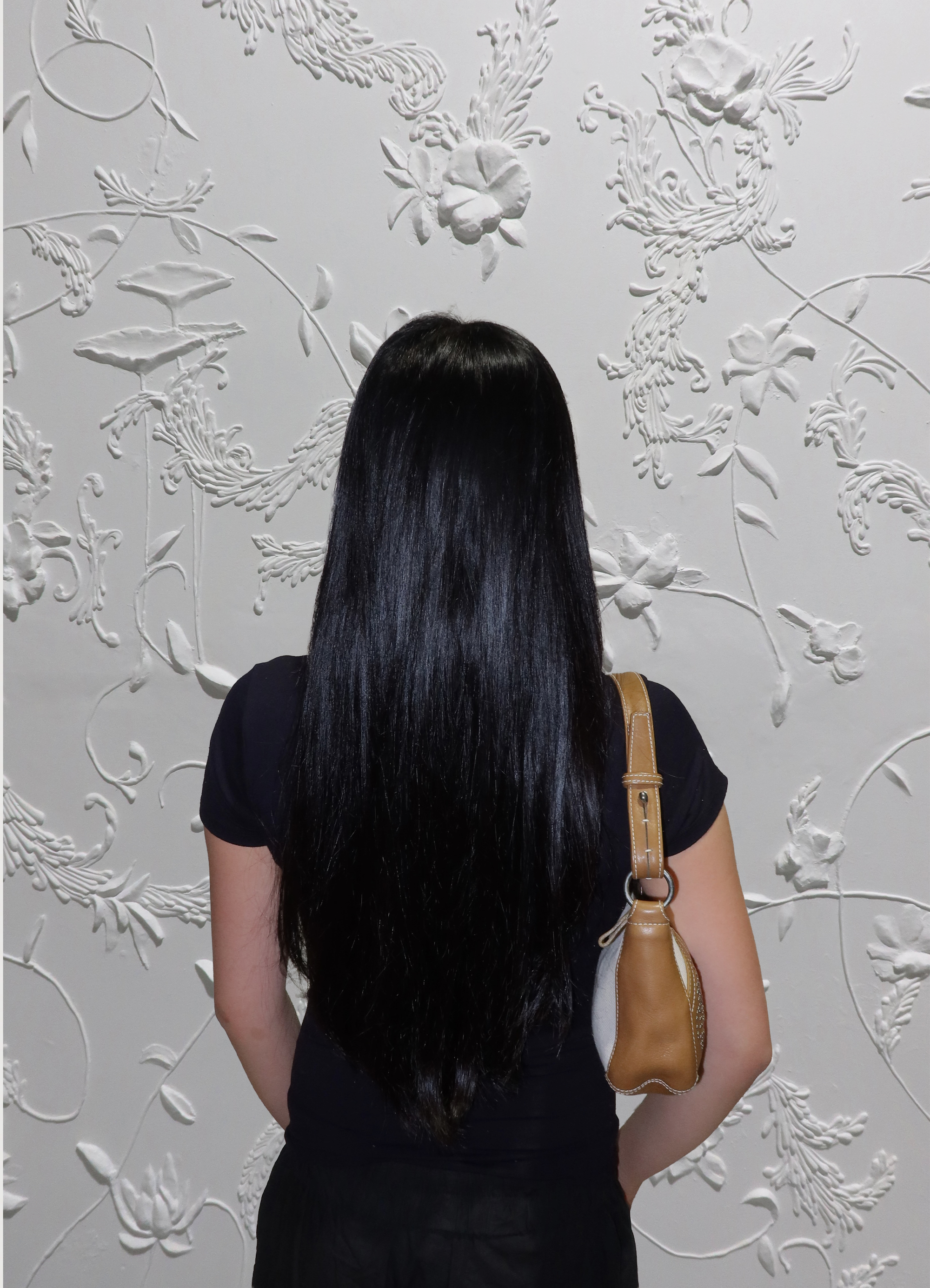 Cream Loewe Anagram pochette bag worn on shoulder by model