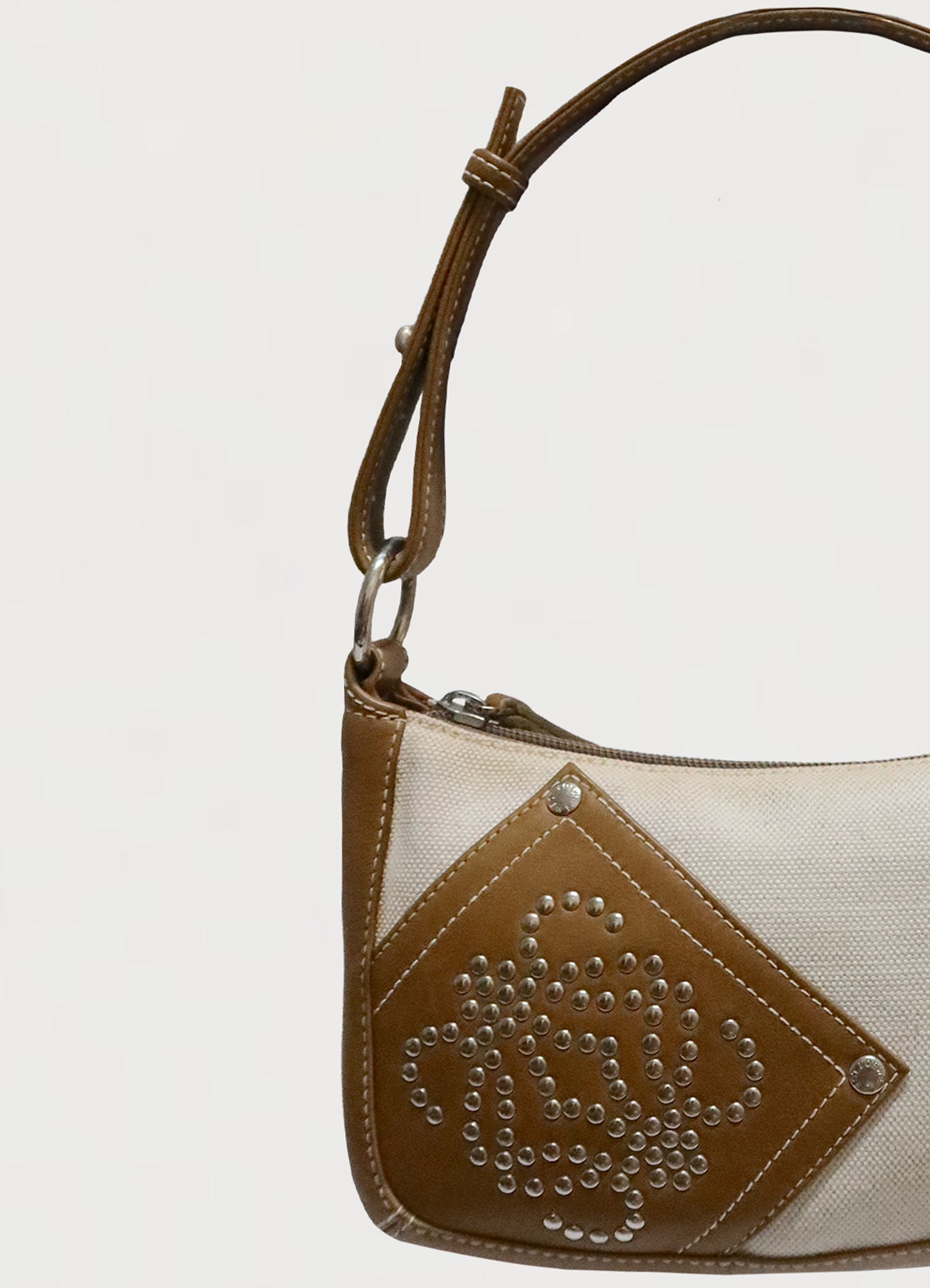 Close up of the adjustable tan leather shoulder strap on Loewe pochette