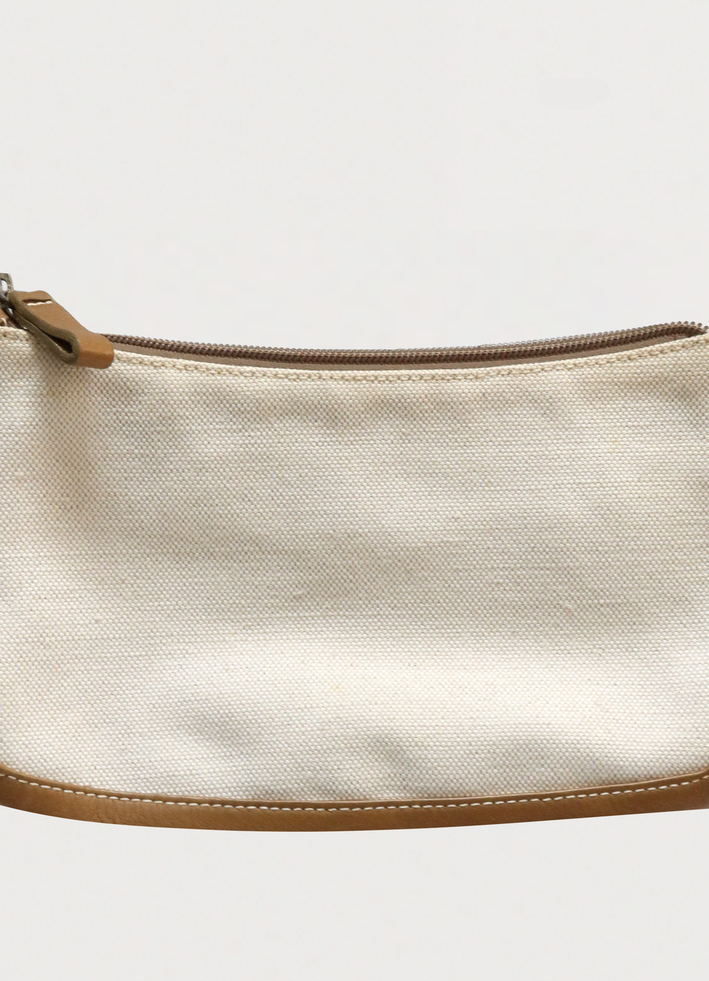 Macro detail of the studded Loewe Anagram logo on the leather corner patch