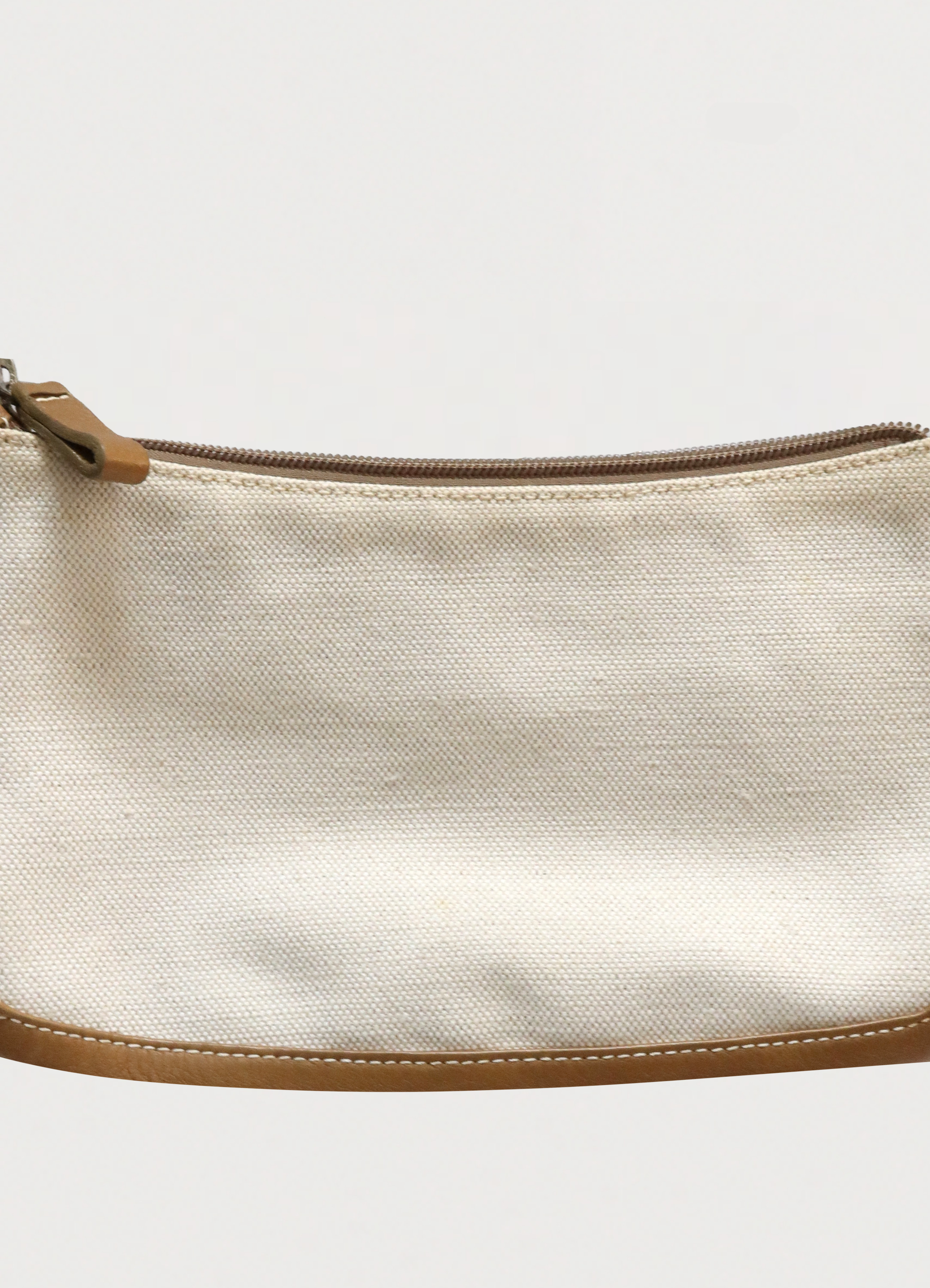 Macro detail of the studded Loewe Anagram logo on the leather corner patch