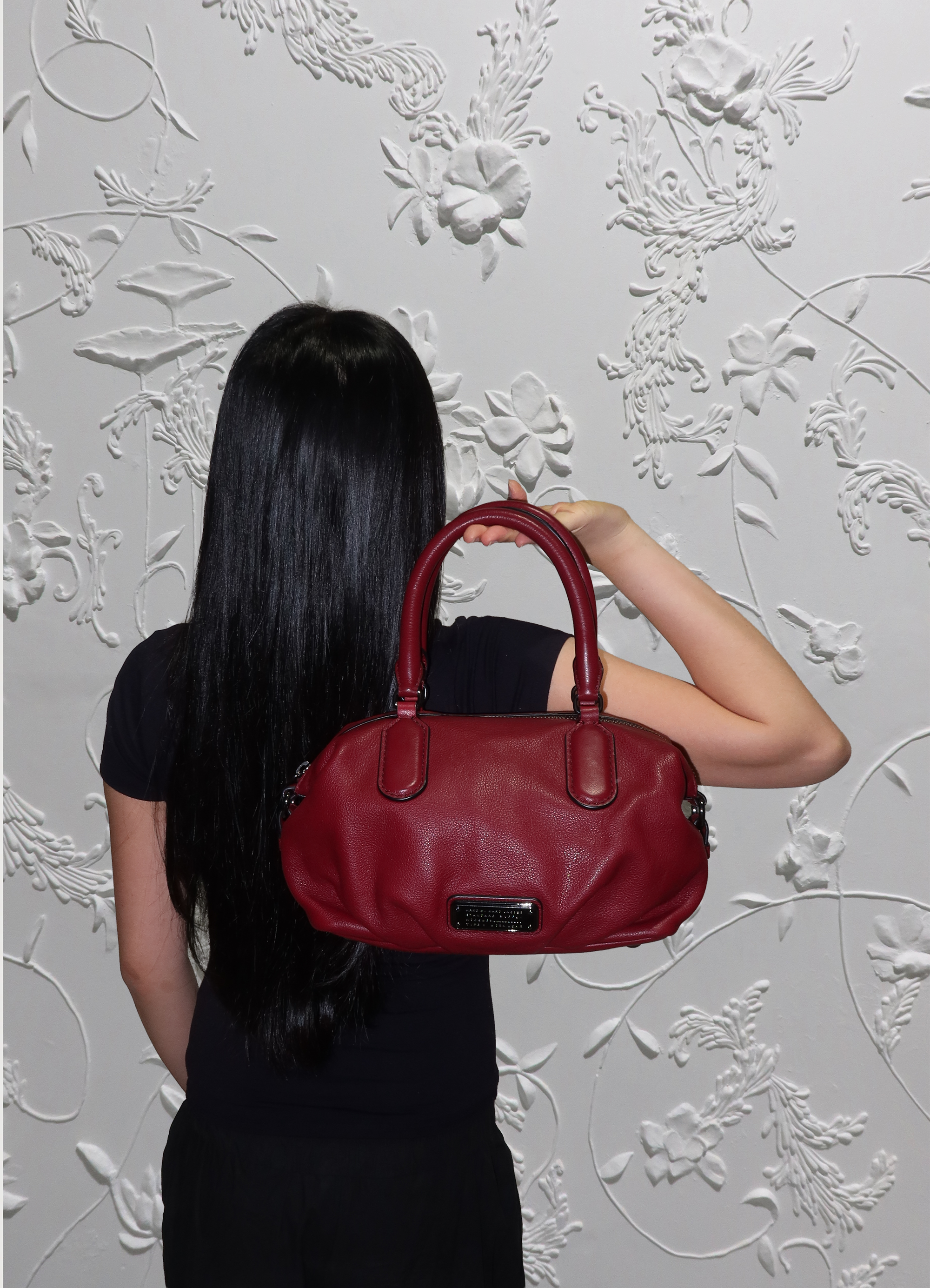 Red Marc Jacobs satchel bag shown on model for scale 