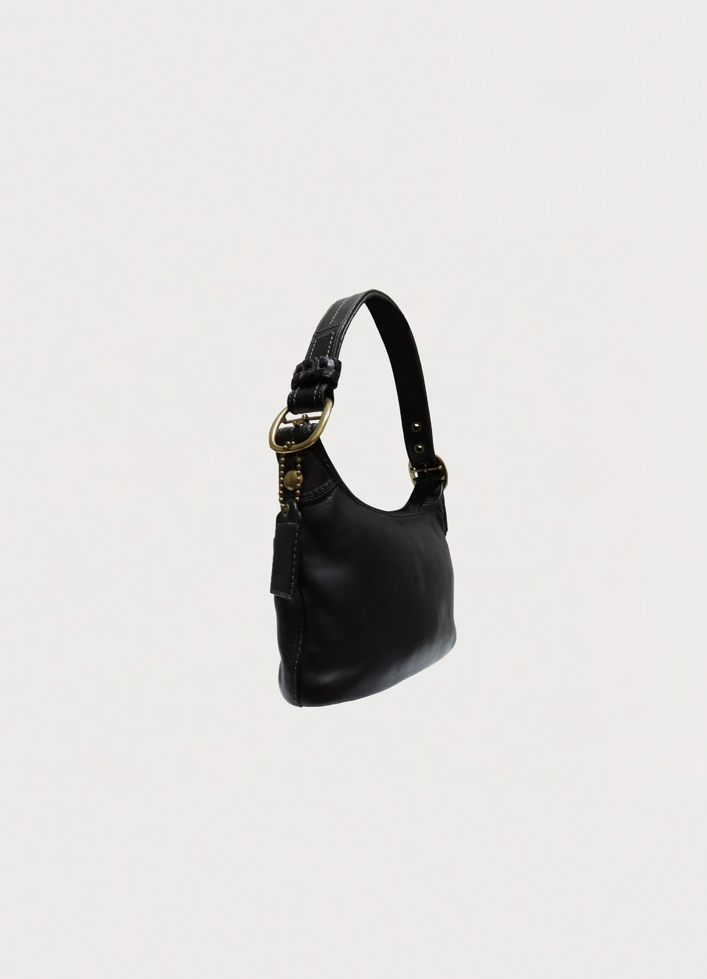 Angled view of black Coach Bleecker leather bag showing the curved hobo silhouette