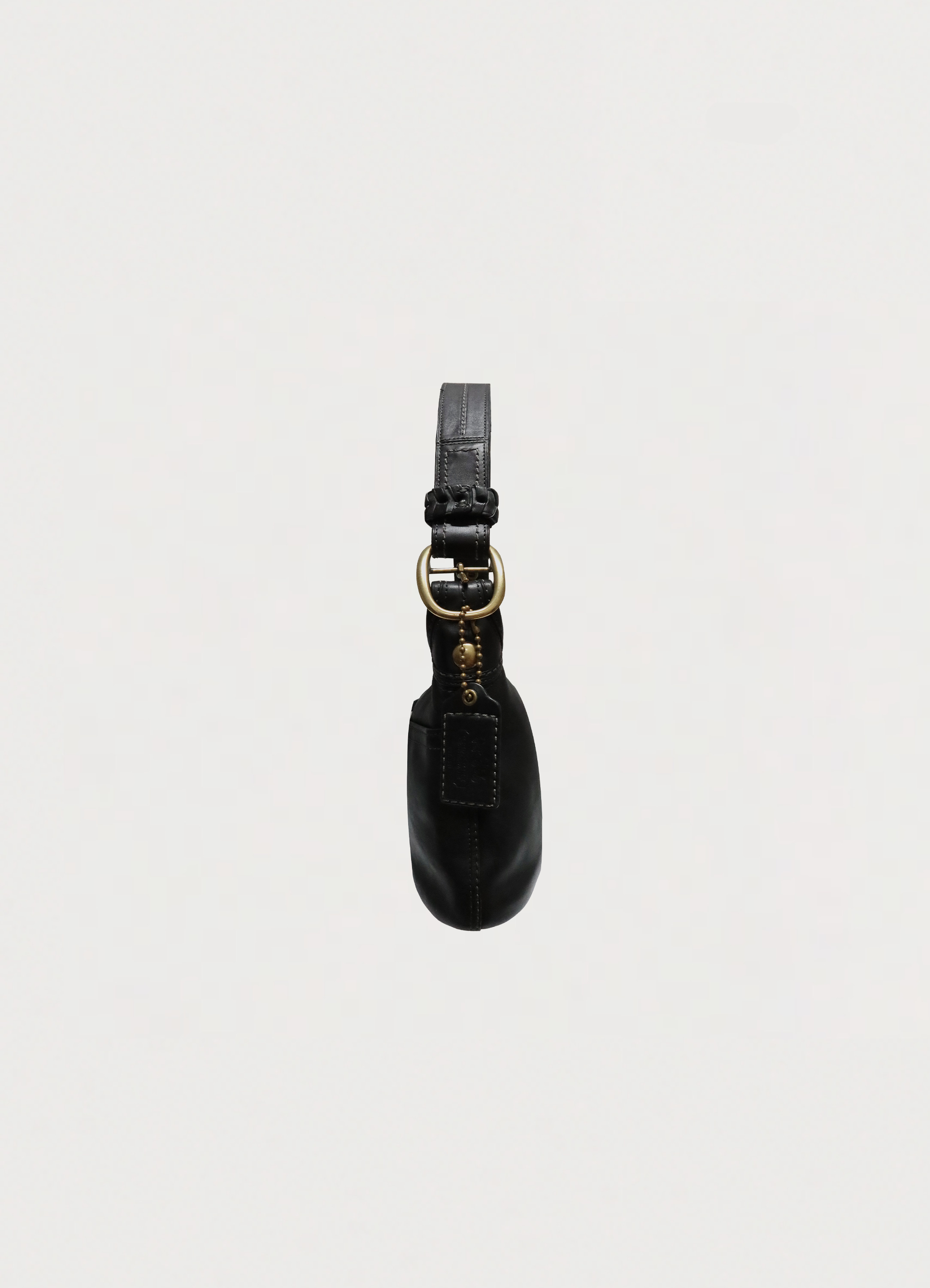 Right side profile of black Coach Bleecker leather hobo bag