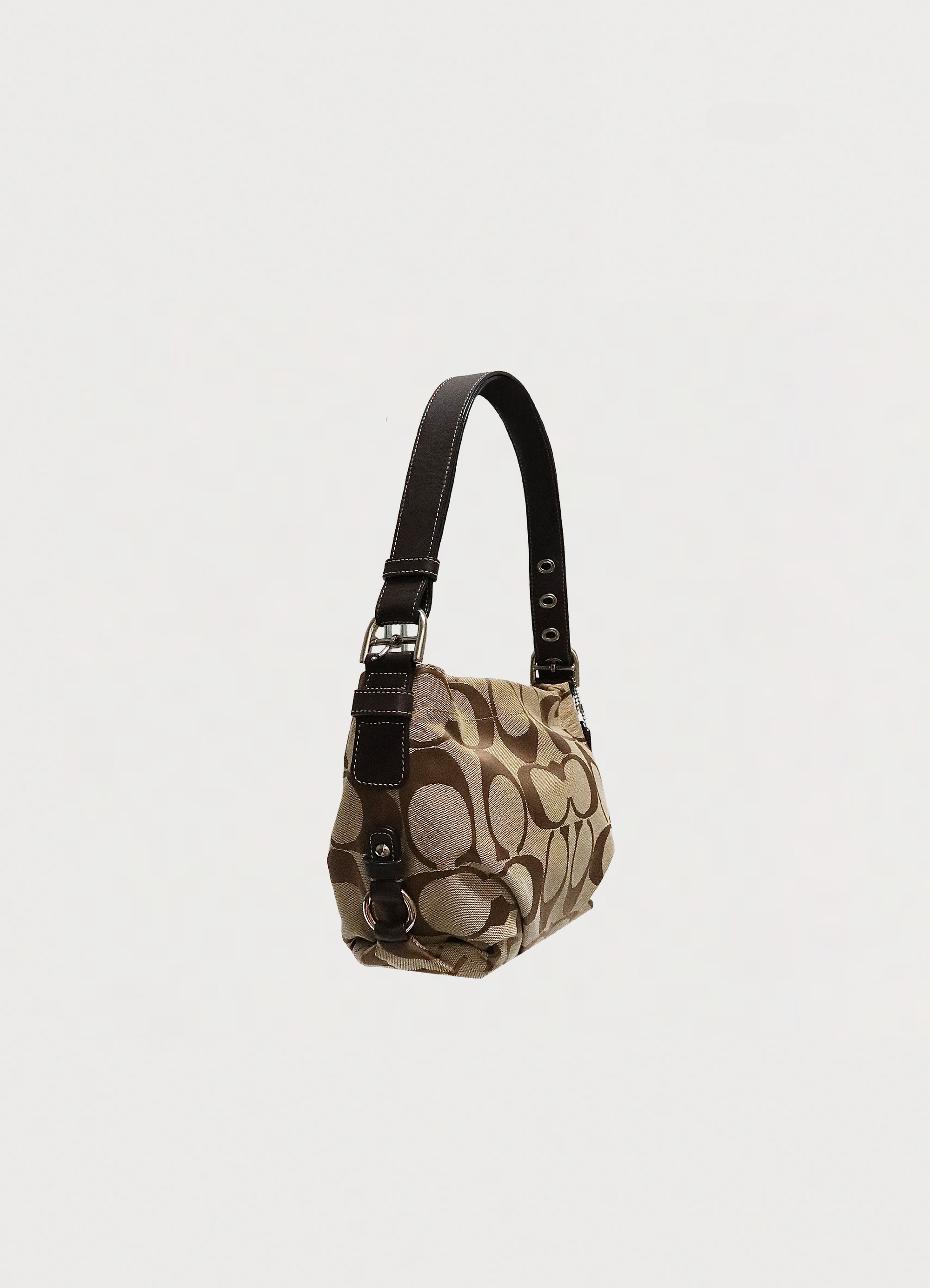 Angled view of Coach Bleecker hobo bag showing slouchy silhouette and canvas texture