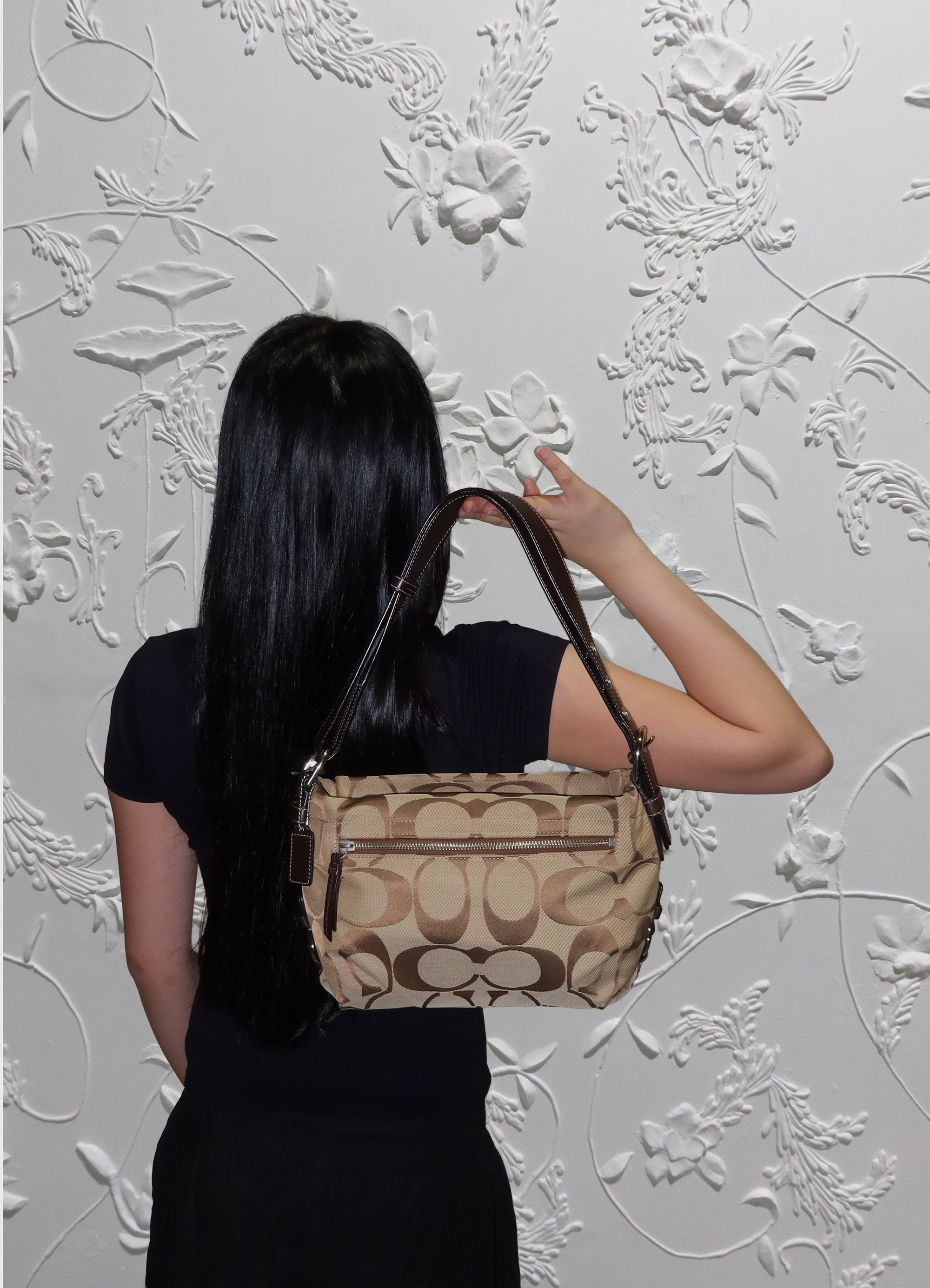 Khaki Coach Bleecker hobo bag held by model