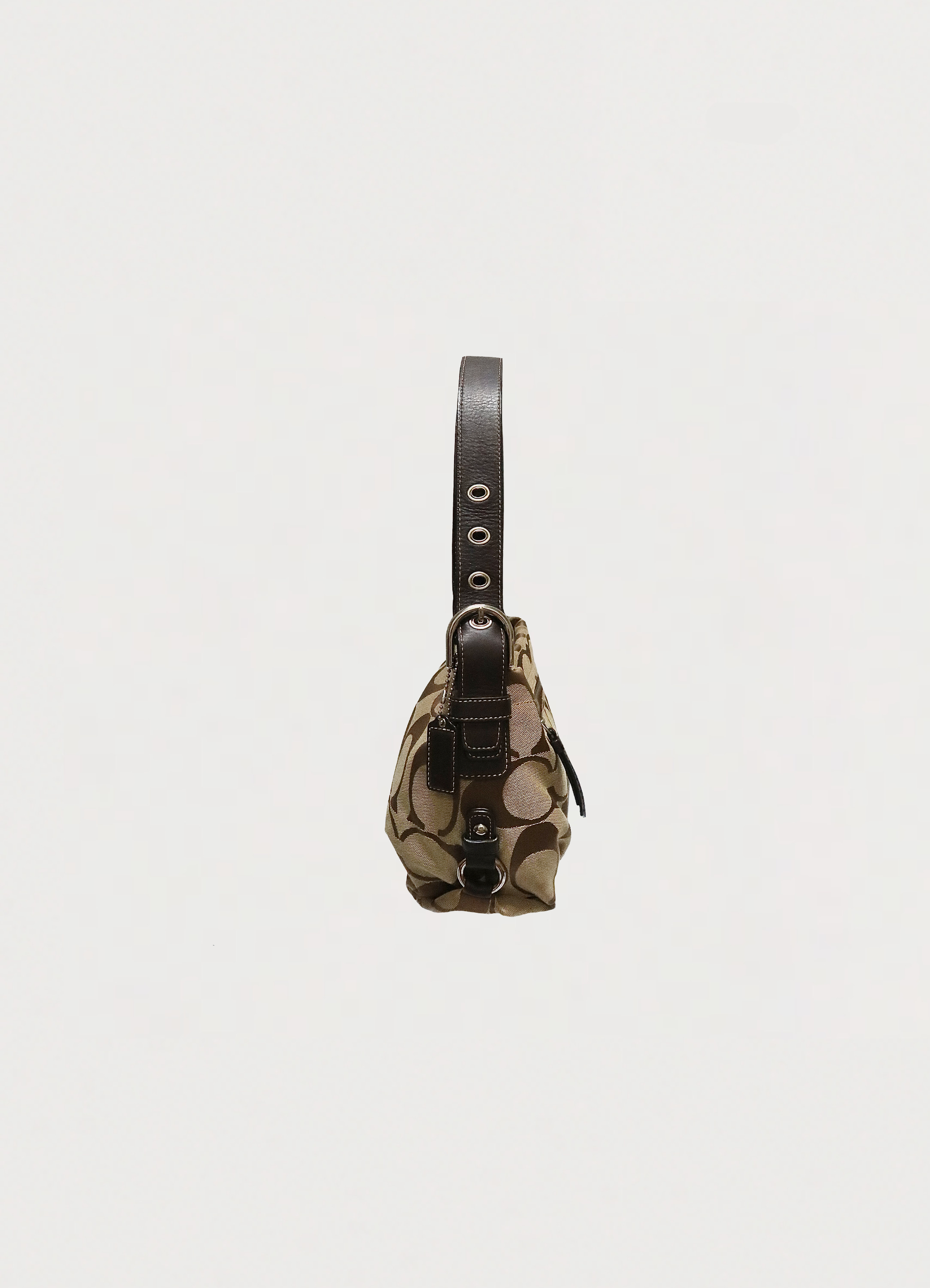 Left side profile of khaki Coach Bleecker signature hobo bag