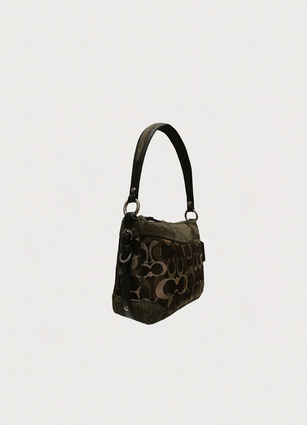 Angled side view of Coach Chelsea optic bag showing suede trim and canvas texture