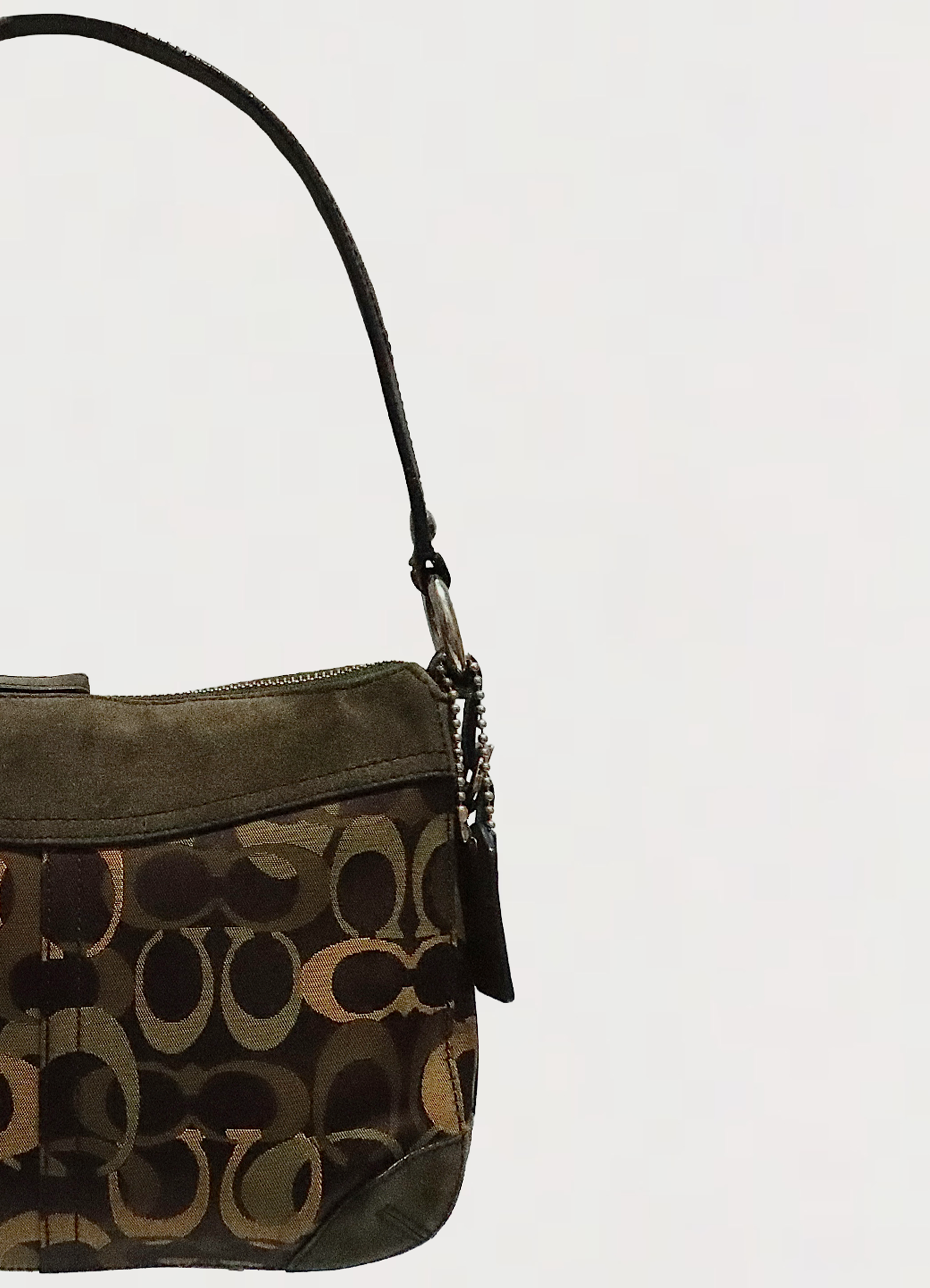 Close up of silver-tone hardware and leather strap attachment on Coach Chelsea bag