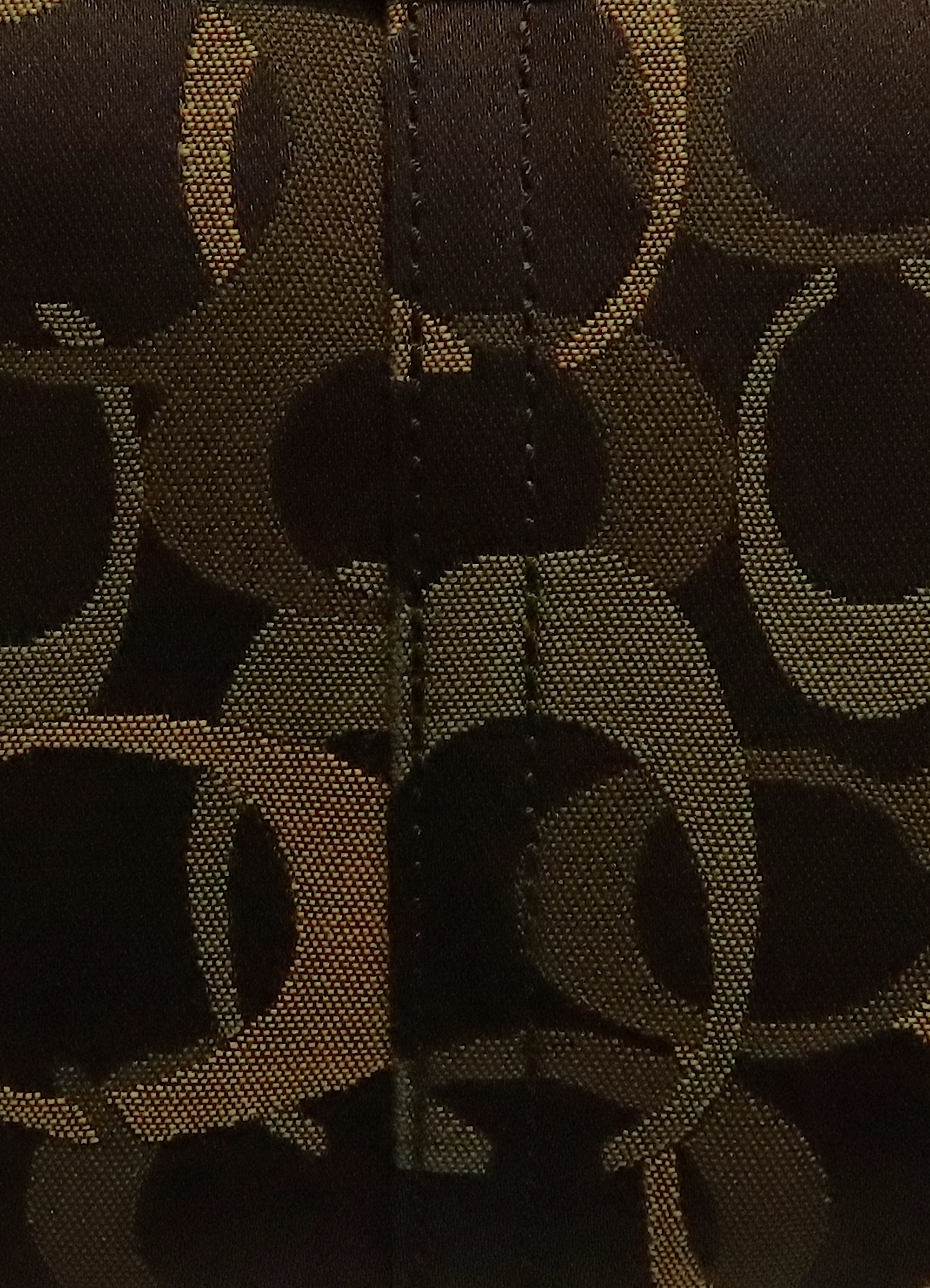 Macro shot of authentic olive khaki Coach optic signature "C" jacquard canvas
