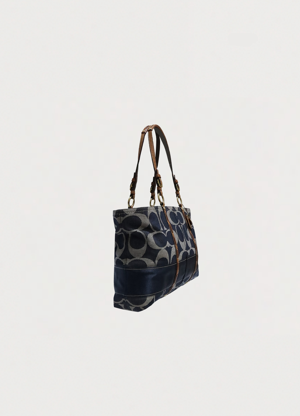 Angled view of Coach denim signature tote showing bag structure