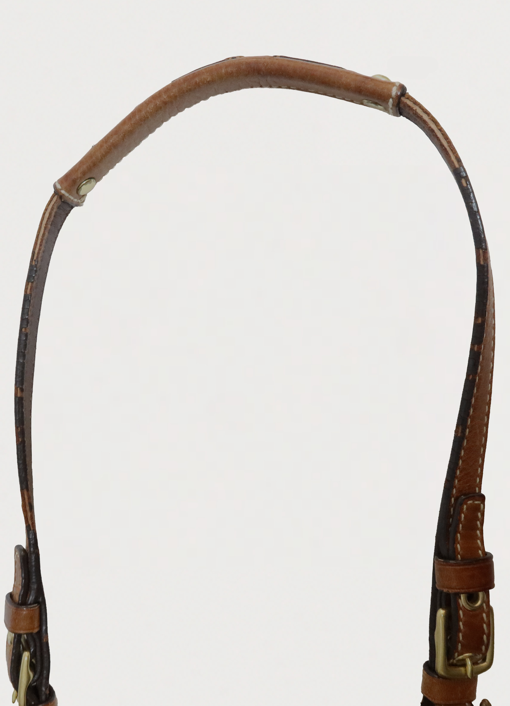 Detail of the tan leather shoulder strap showing stitching and edge paint
