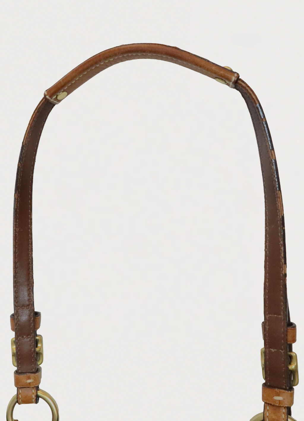 Top view of tan leather handles on the vintage Coach denim tote