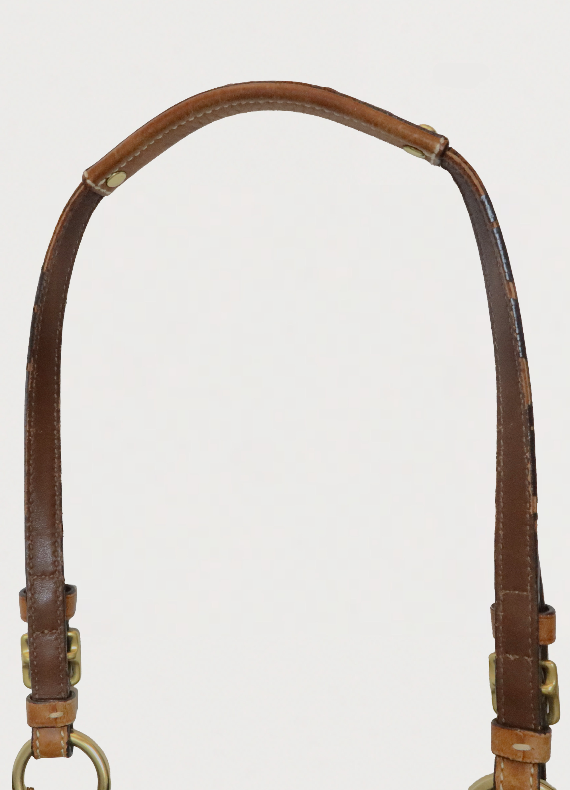 Top view of tan leather handles on the vintage Coach denim tote