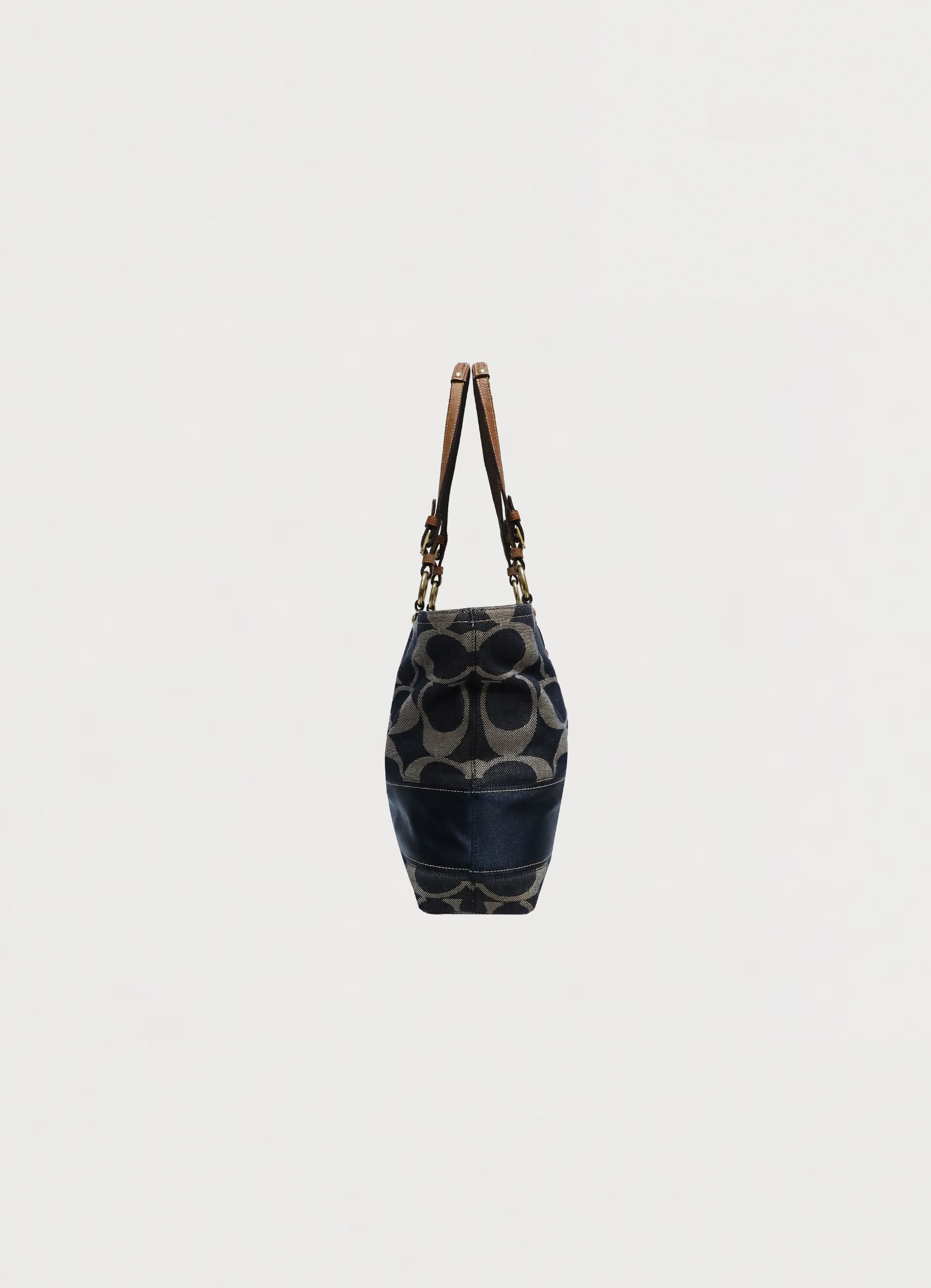 Right side profile of blue denim Coach Legacy tote bag
