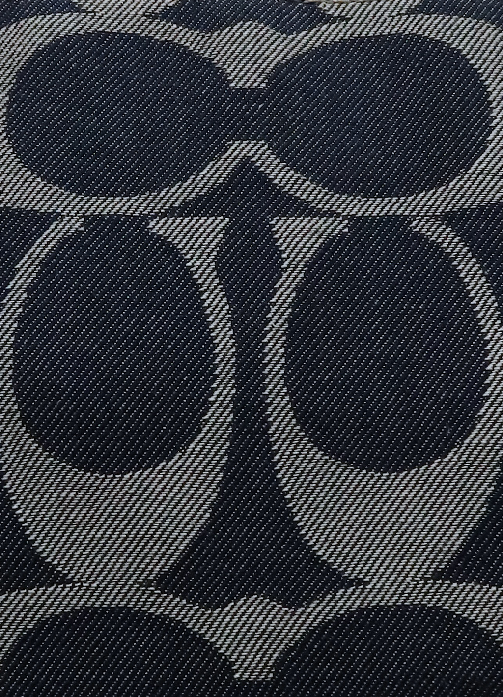 Macro shot of authentic blue denim Coach signature "C" jacquard pattern