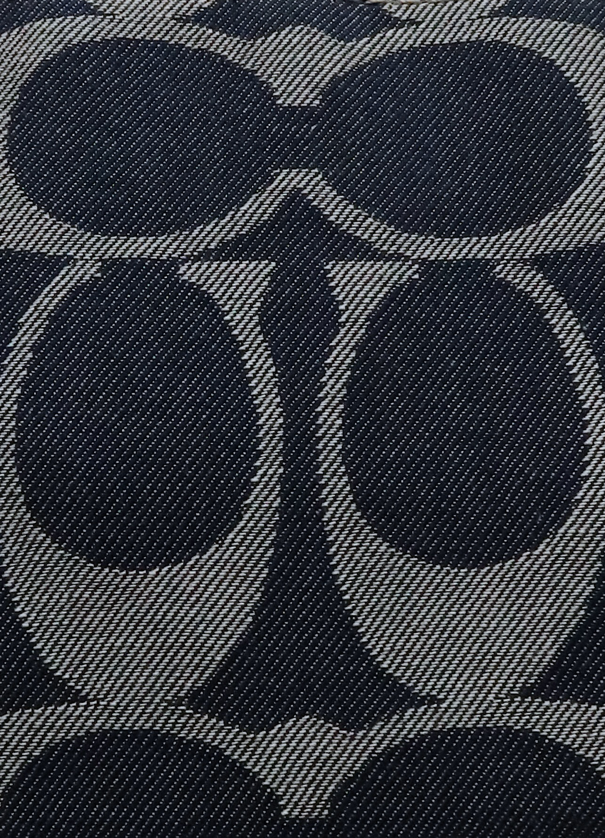 Macro shot of authentic blue denim Coach signature "C" jacquard pattern