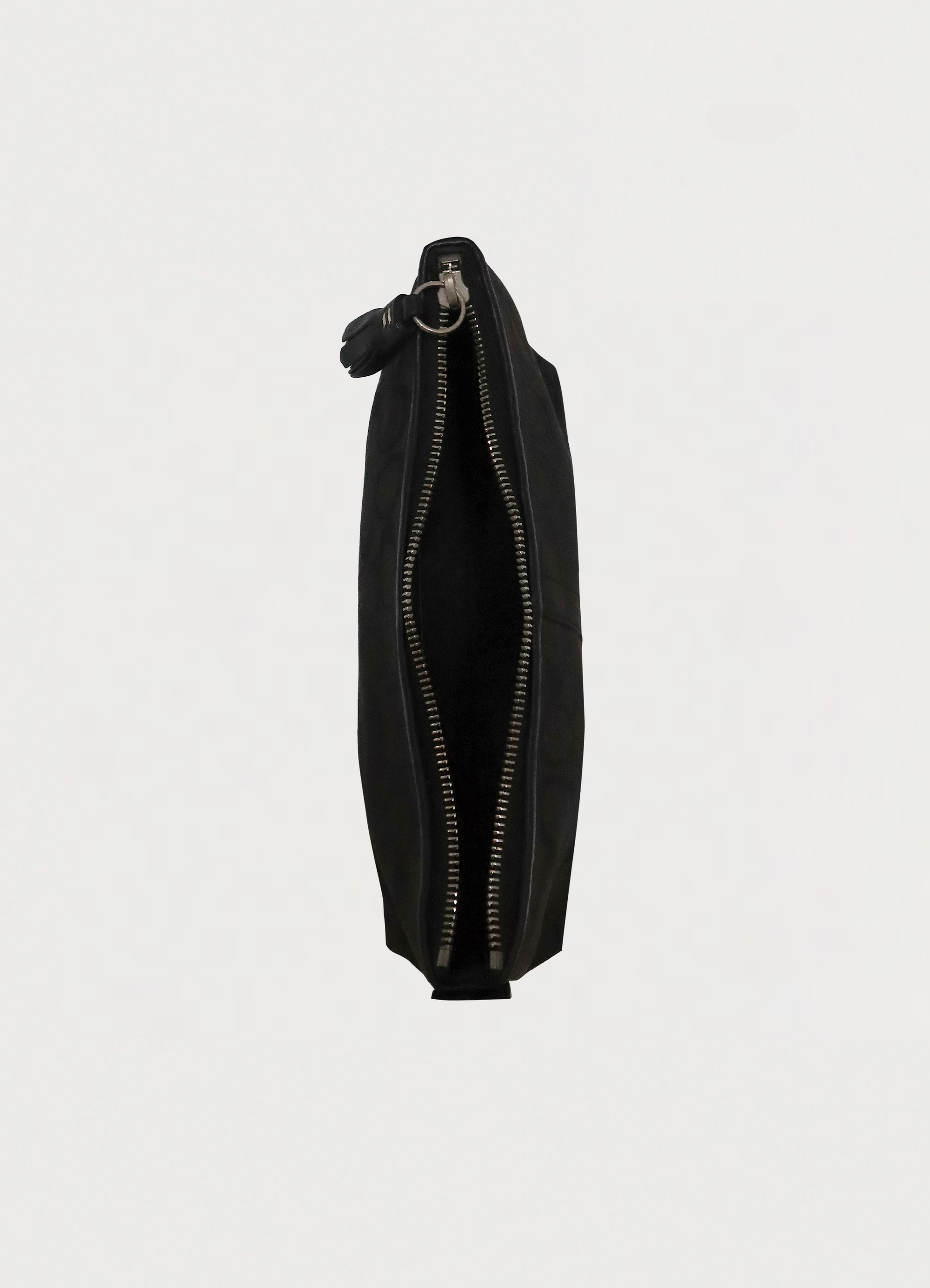Top view of black Coach baguette bag showing interior and zipper opening