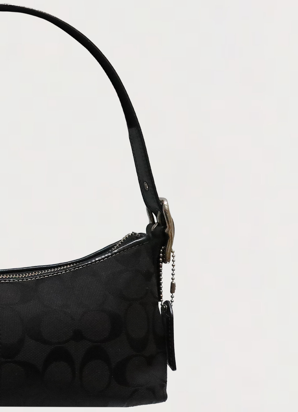 Close up of the adjustable black leather shoulder strap and buckle hardware