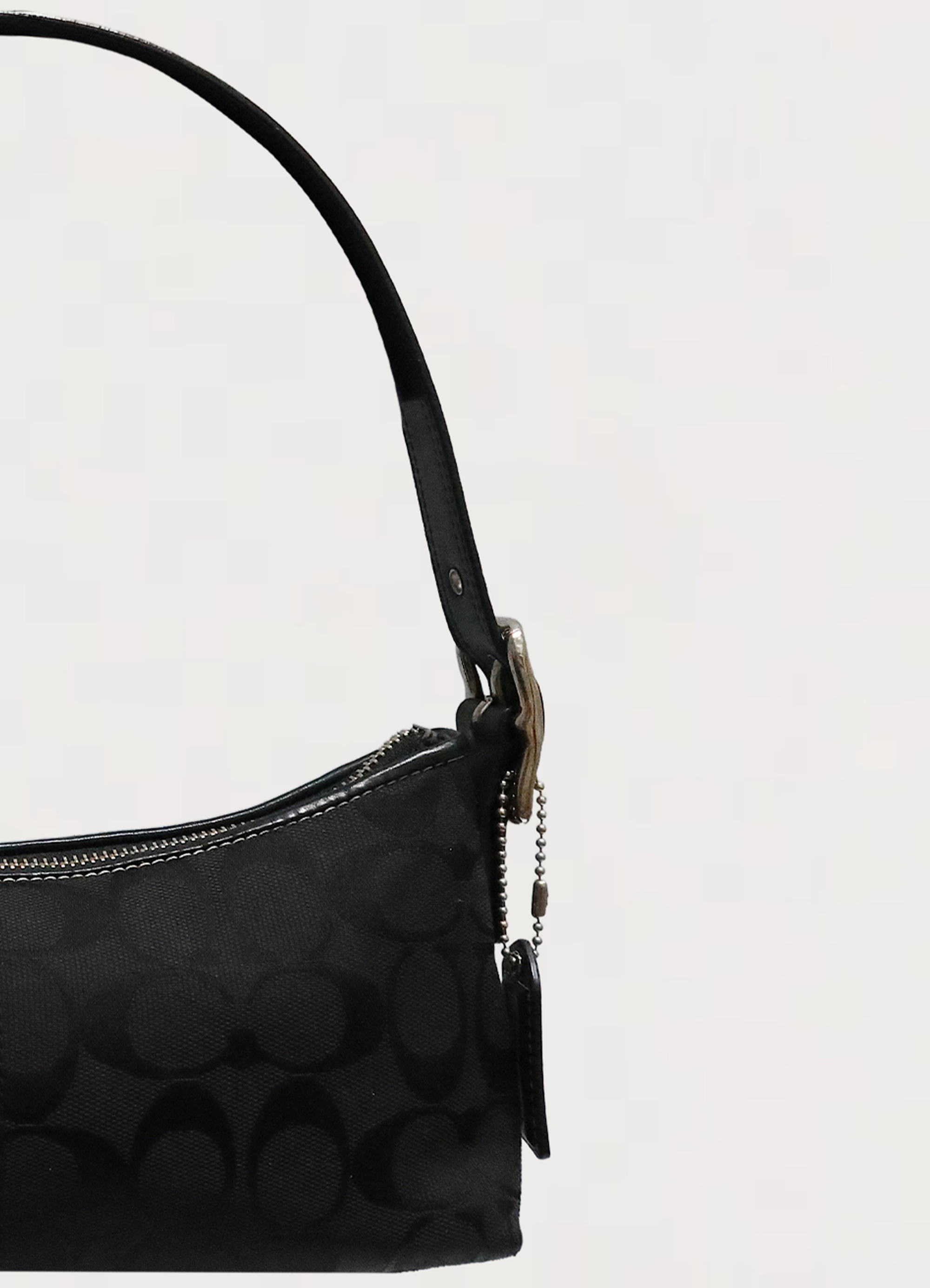 Close up of the adjustable black leather shoulder strap and buckle hardware