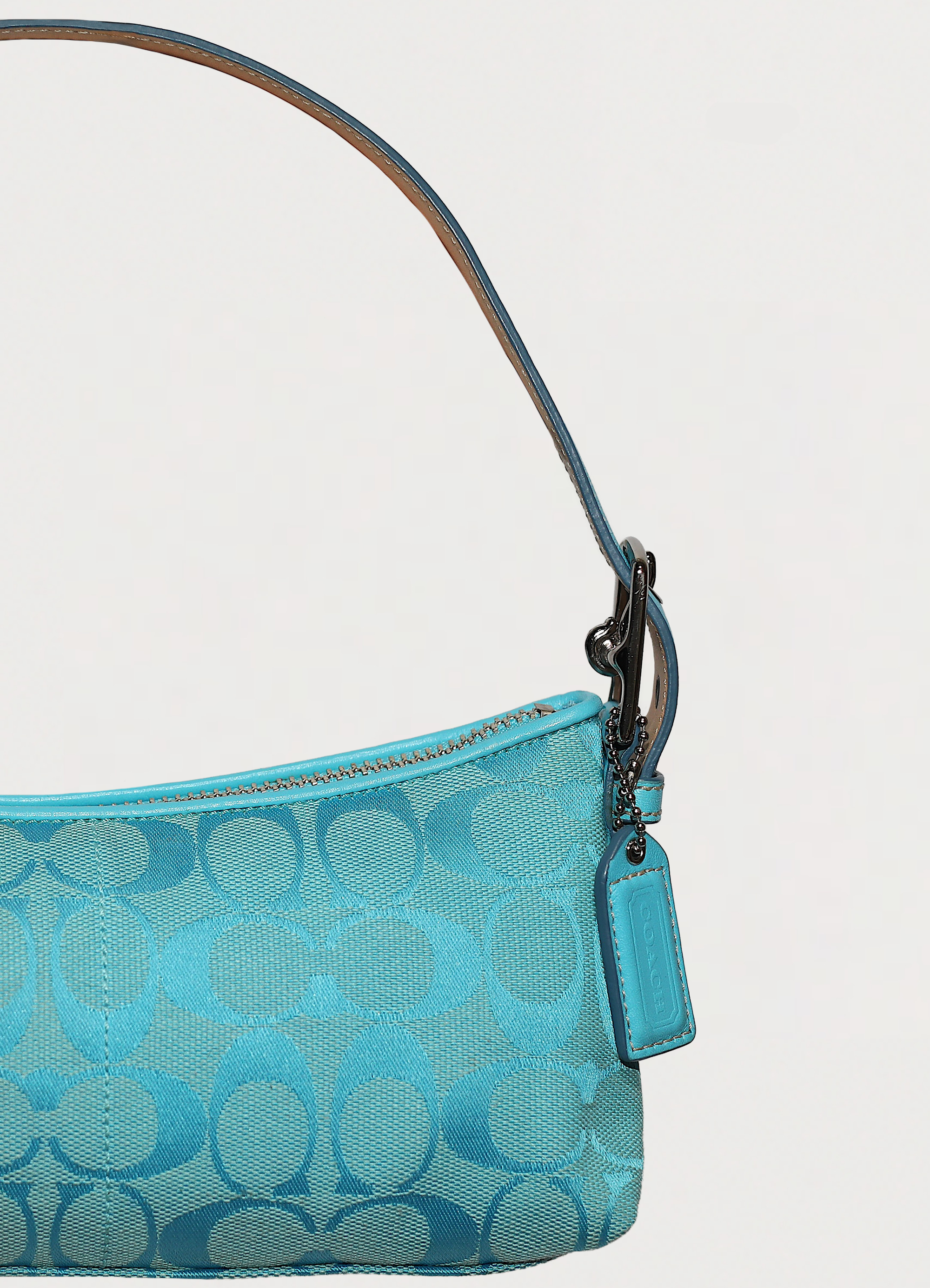 Vintage Coach East West demi bag in blue signature canvas with leather trim showing close up of hang tag