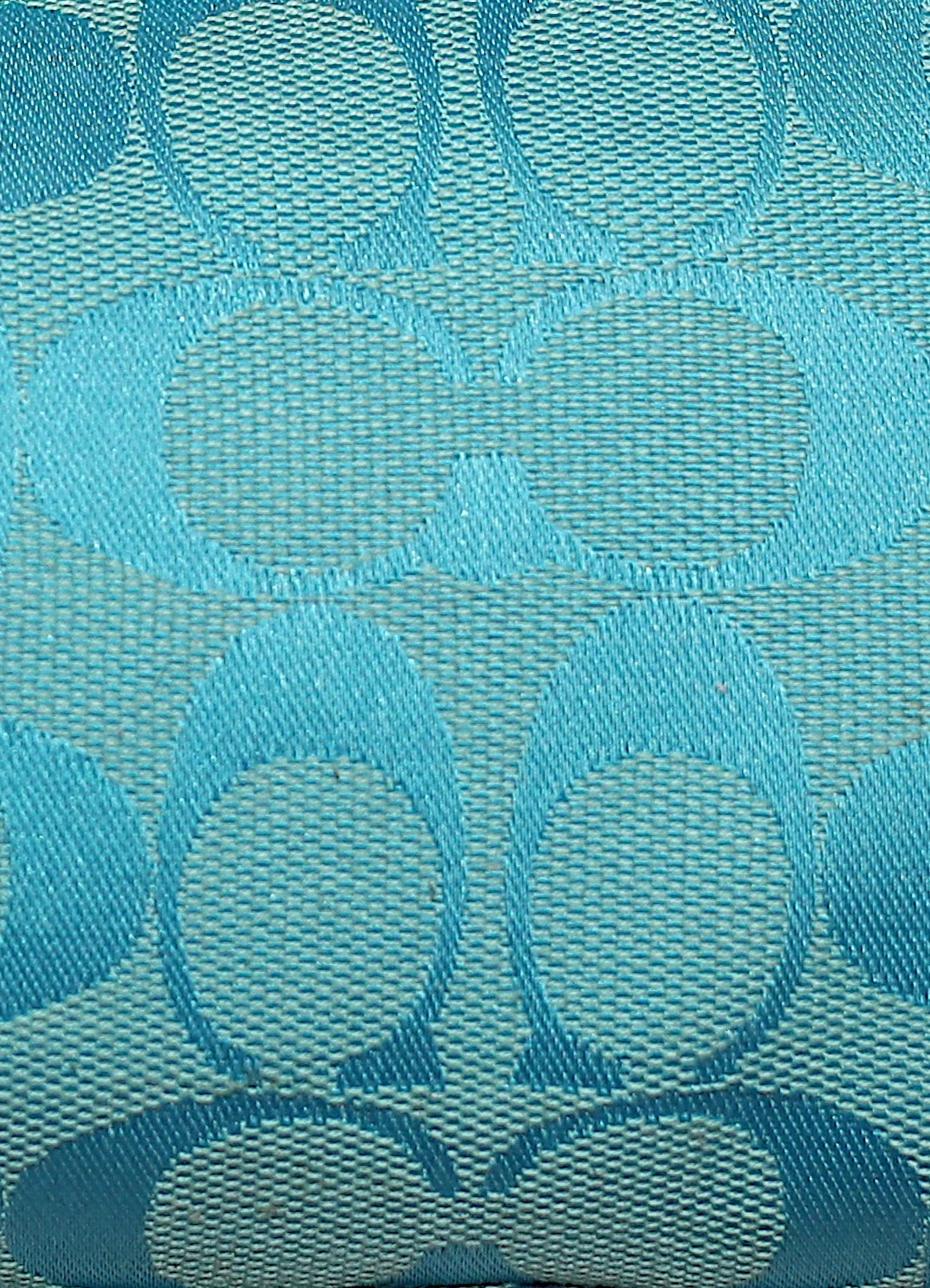 Vintage Coach East West demi bag in blue signature canvas with leather trim showing close up of print