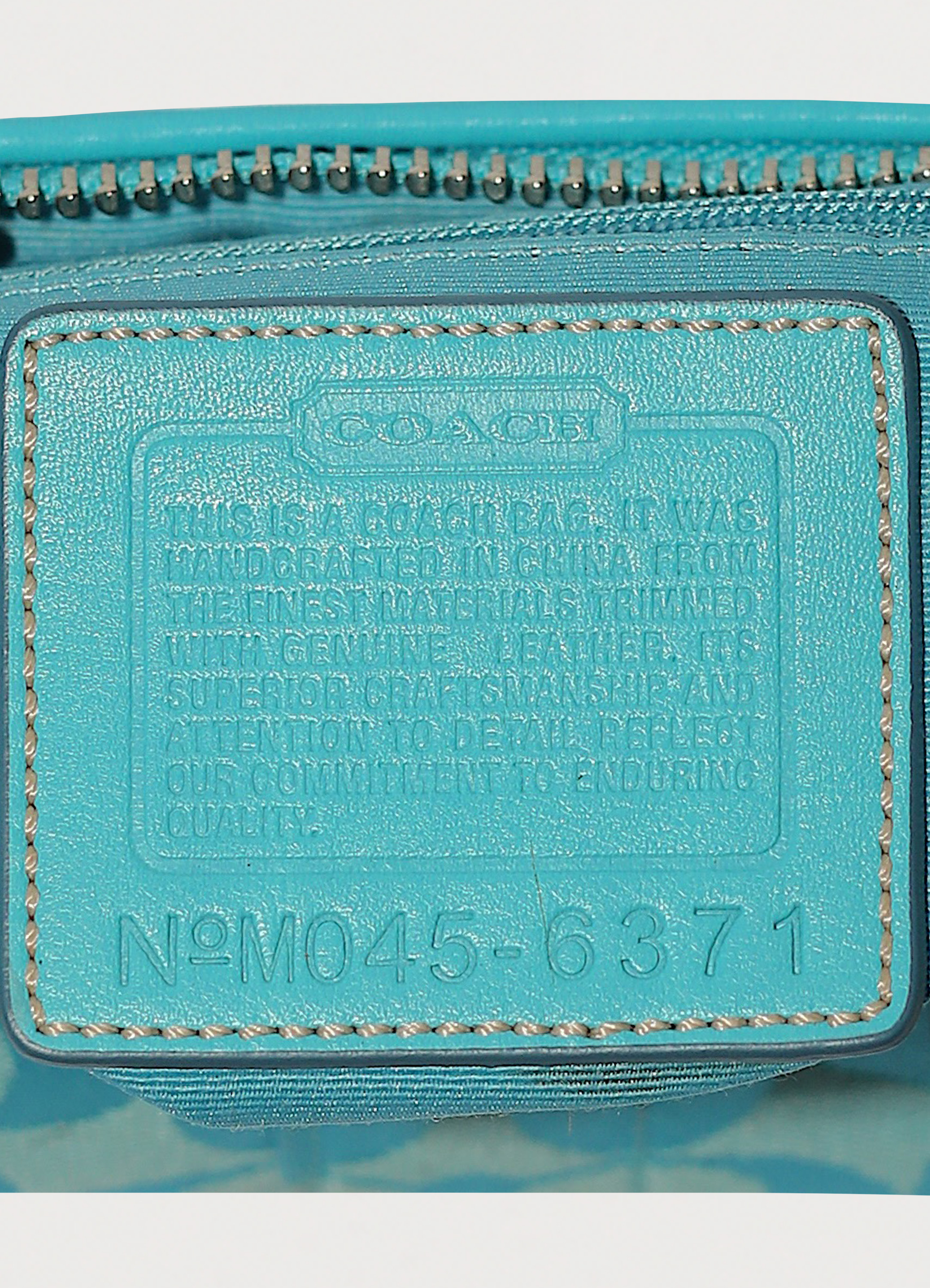Vintage Coach East West demi bag in blue signature canvas with leather trim showing creed patch