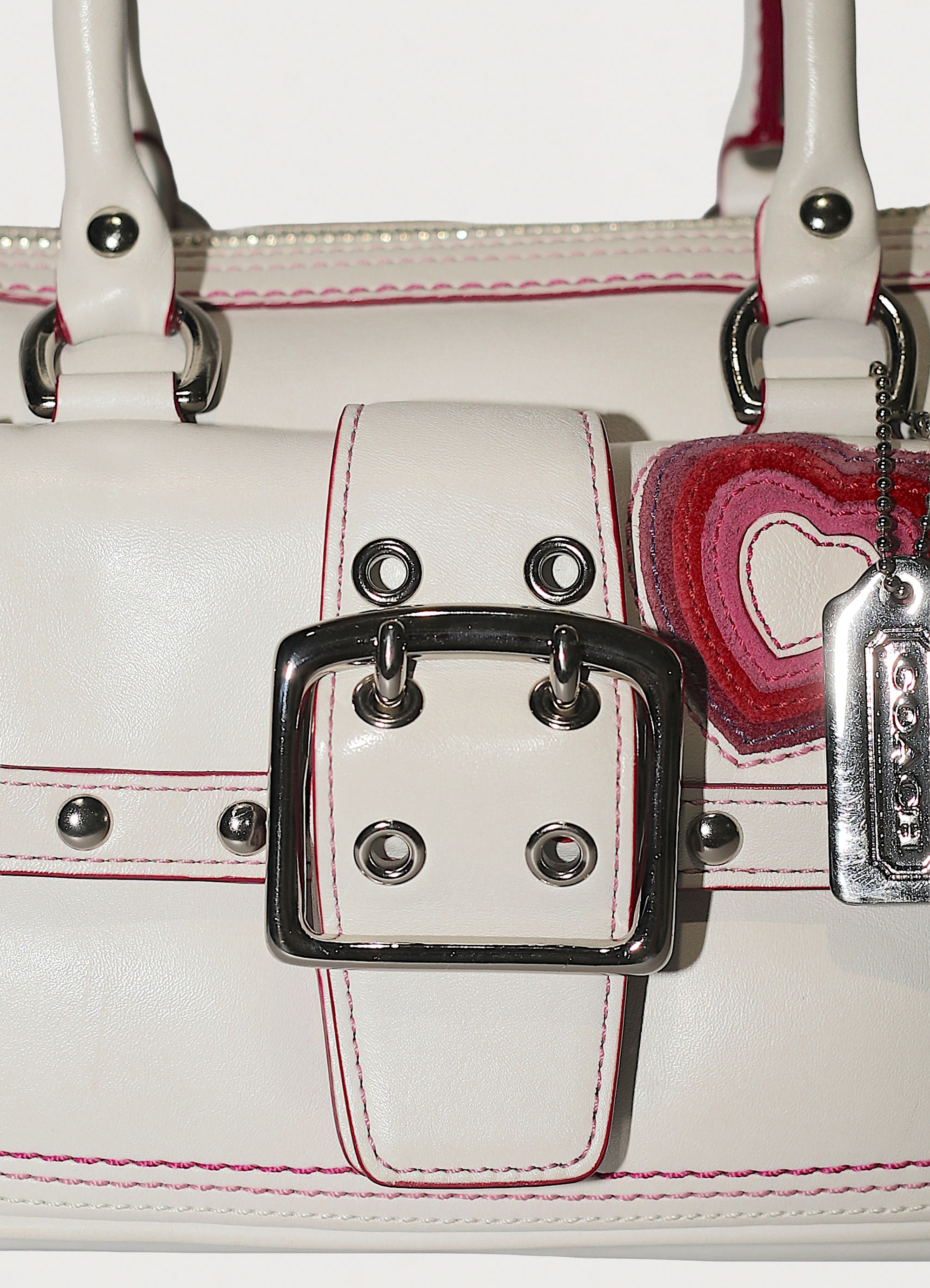 Vintage Coach embroidered heart satchel in leather with suede trim showing close up of buckle at front