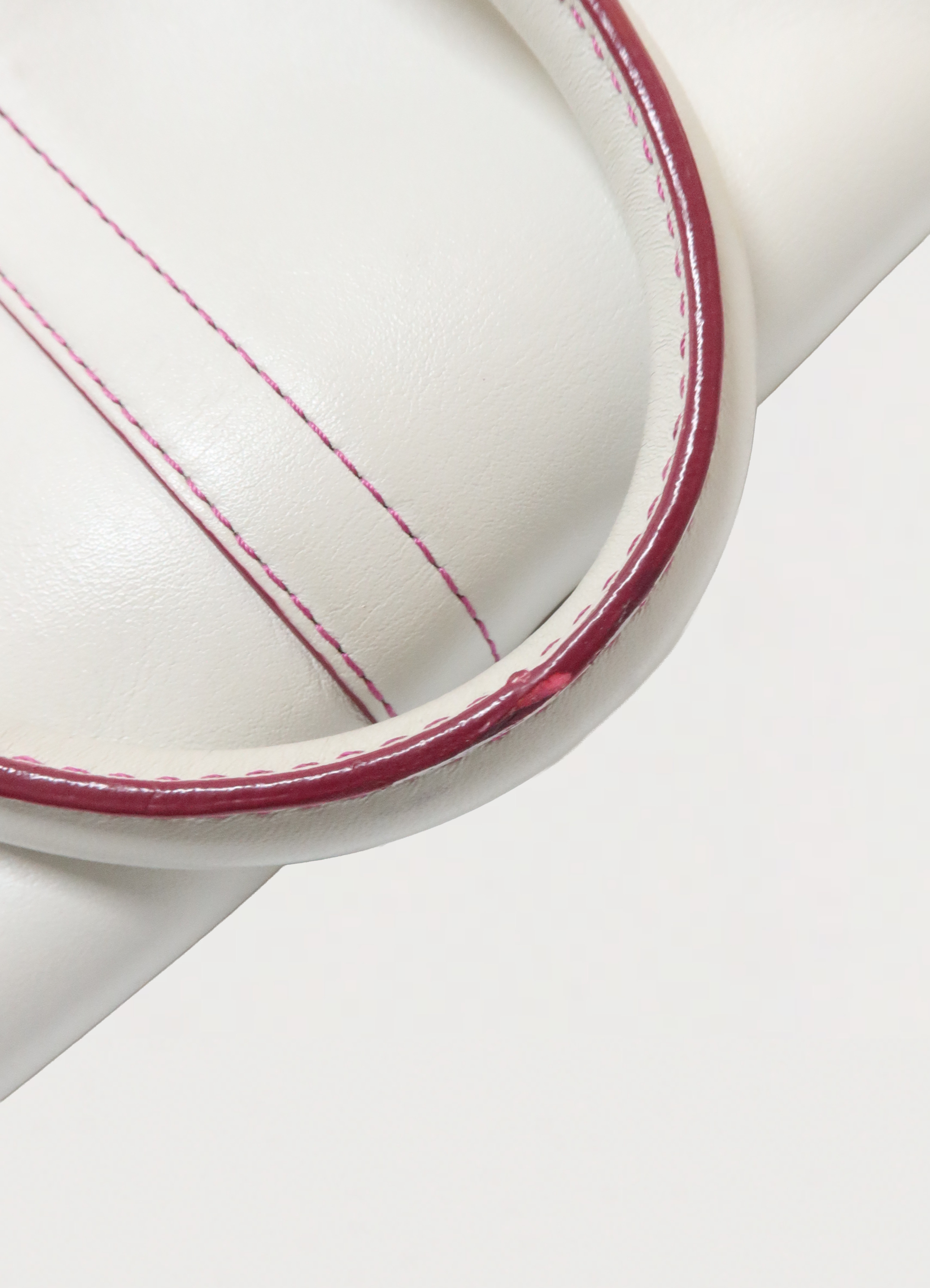 Close up of rolled white leather handles with signature Poppy red edge paint
