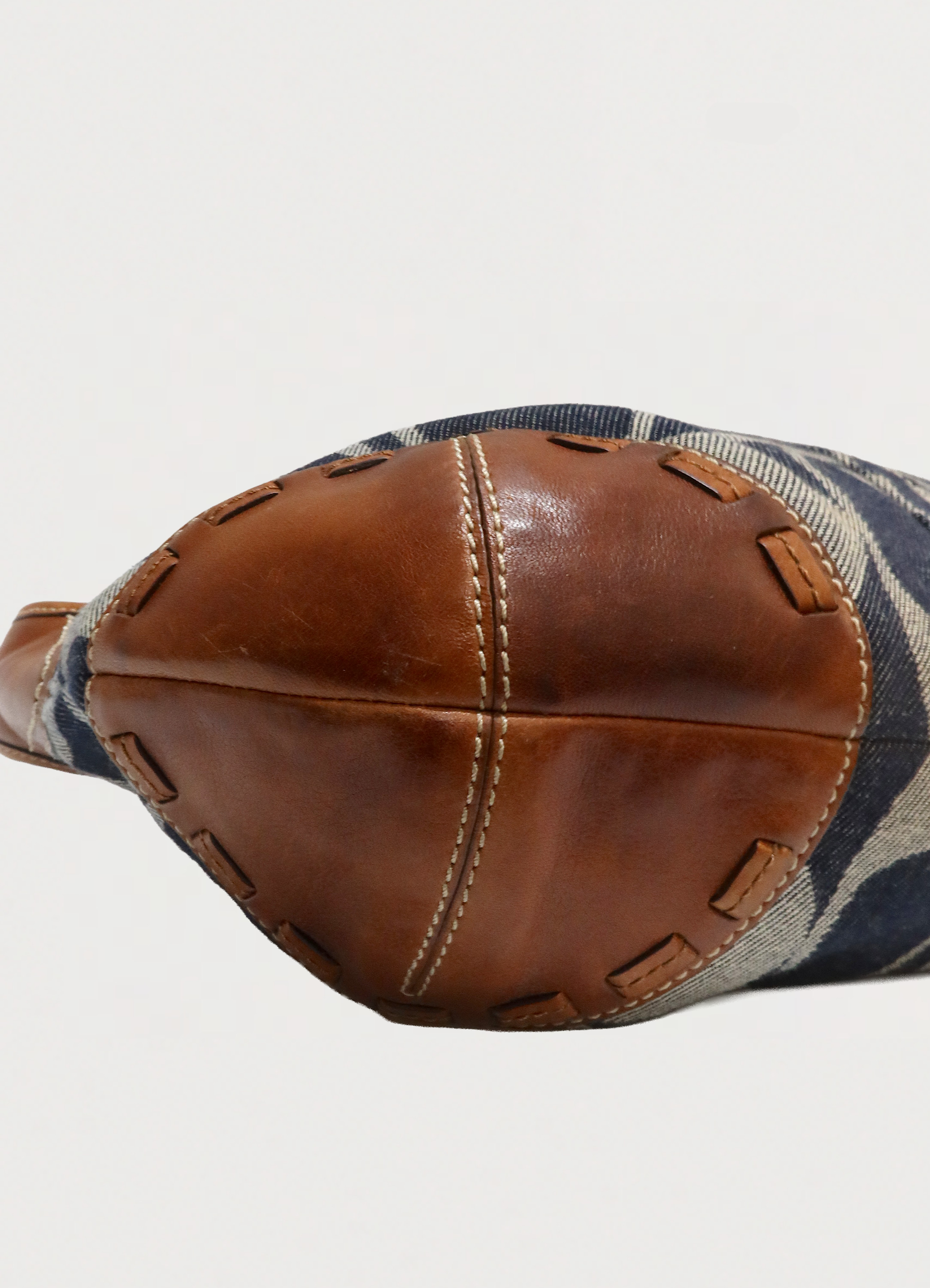 Close up of the reinforced leather base and contrast stitching on the Coach Ergo bag