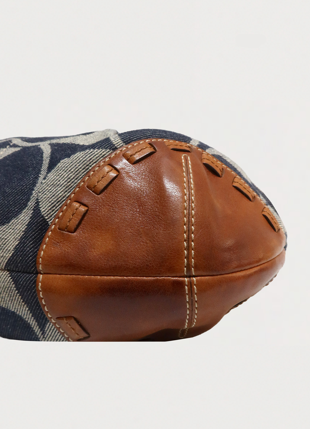 Detailed shot of the cognac leather corner and whipstitching on the Ergo hobo