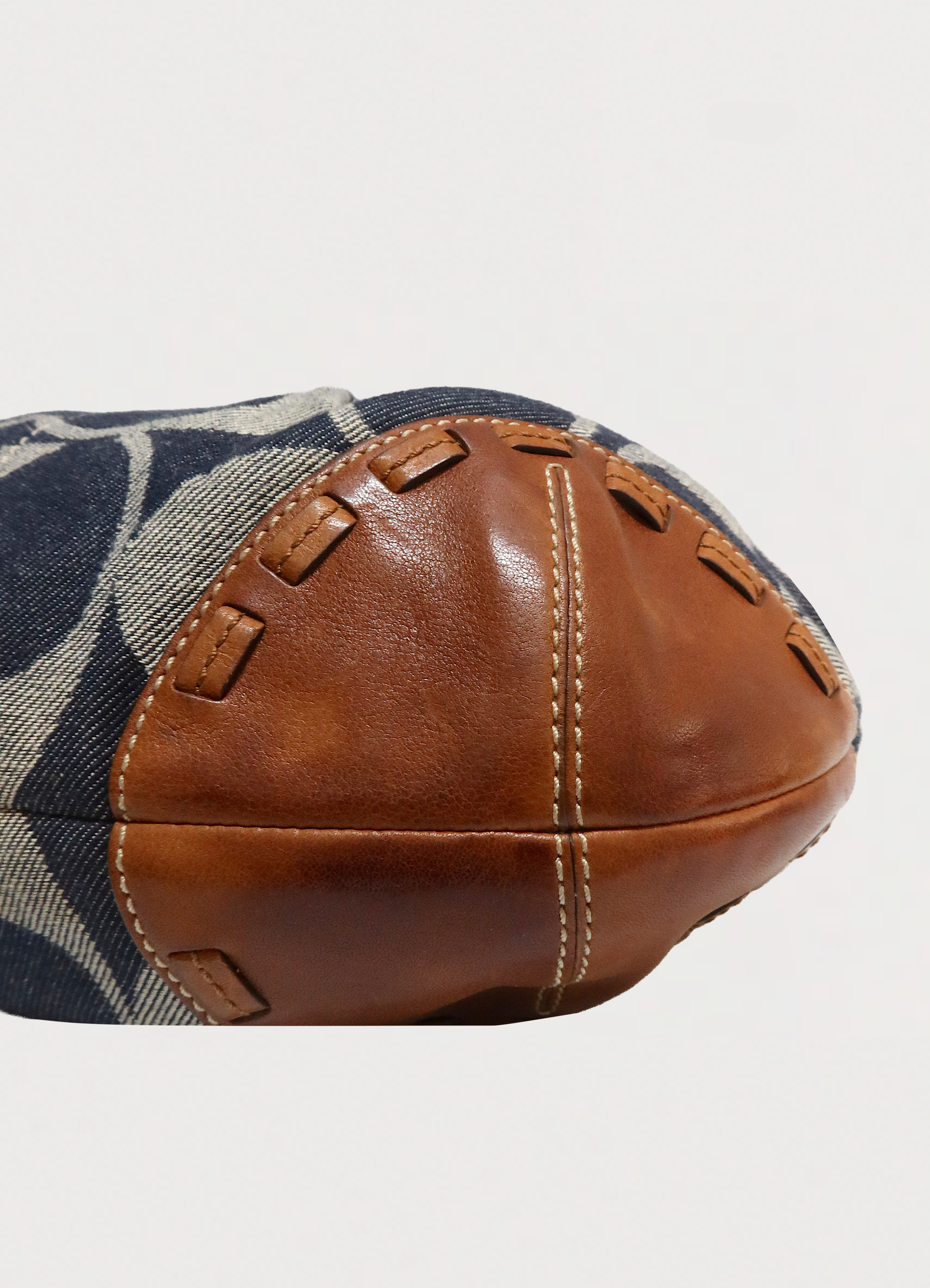 Detailed shot of the cognac leather corner and whipstitching on the Ergo hobo