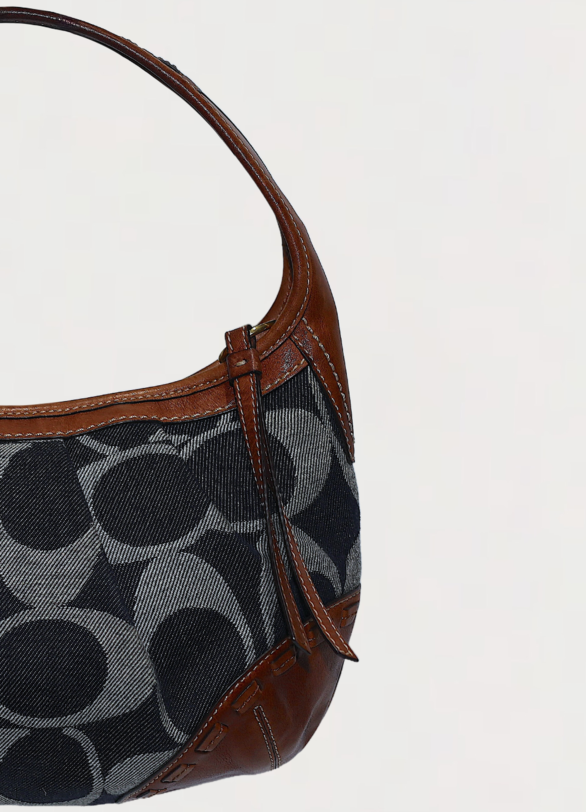 Vintage Coach Ergo monogram hobo in blue signature canvas with leather trim showing close up of left side