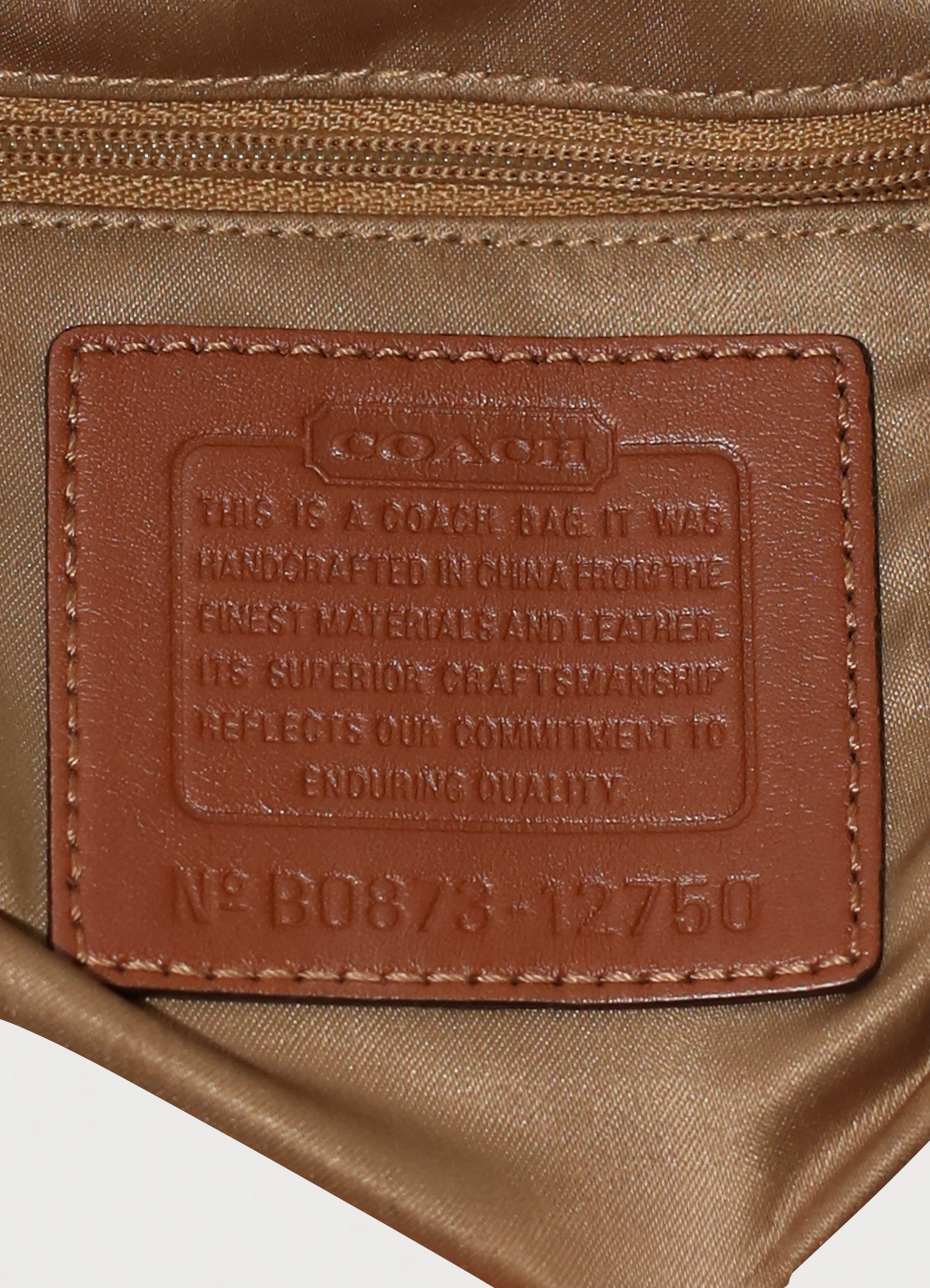 Vintage Coach Ergo monogram hobo in blue signature canvas with leather trim showing close up of creed patch
