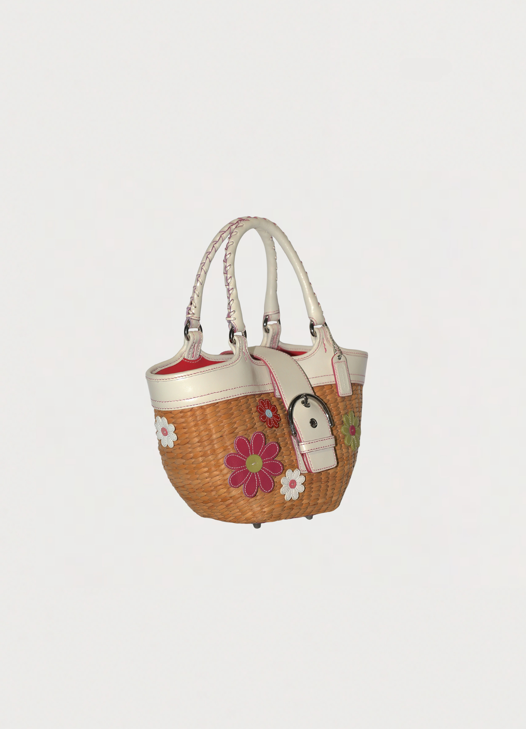 Vintage Coach Flowered straw handbag in white leather trim showing angled side