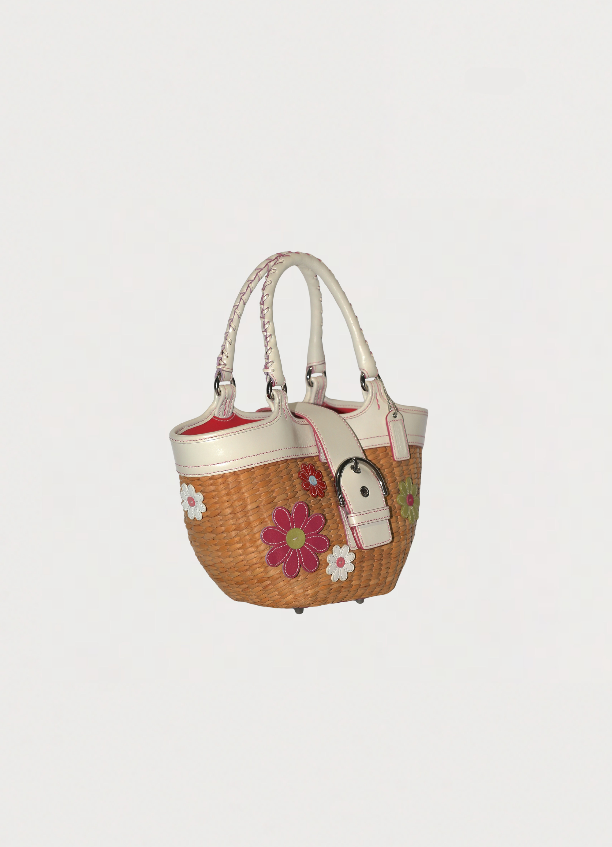 Vintage Coach Flowered straw handbag in white leather trim showing angled side
