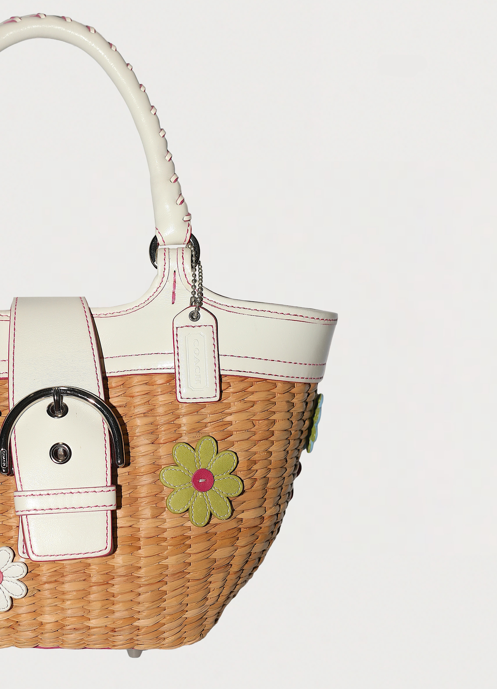 Vintage Coach Flowered straw handbag in white leather trim showing close up of hang tag